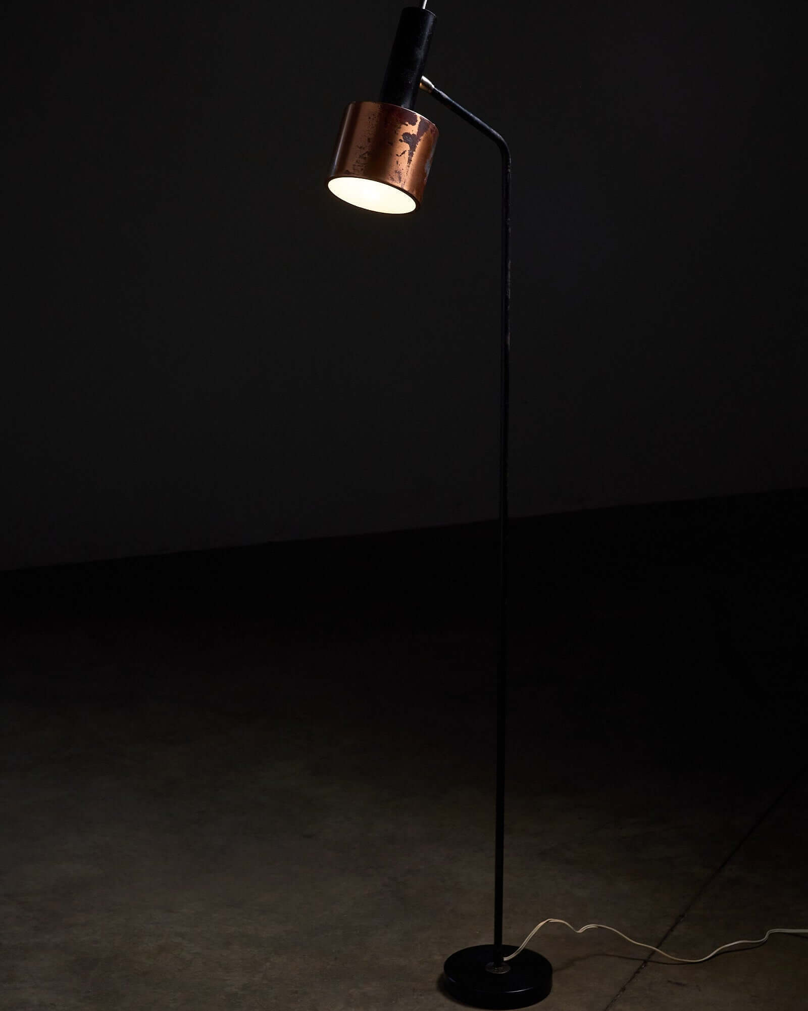 Floor lamp in black steel and copper shade, 1970s with a warm glow and elegant design.