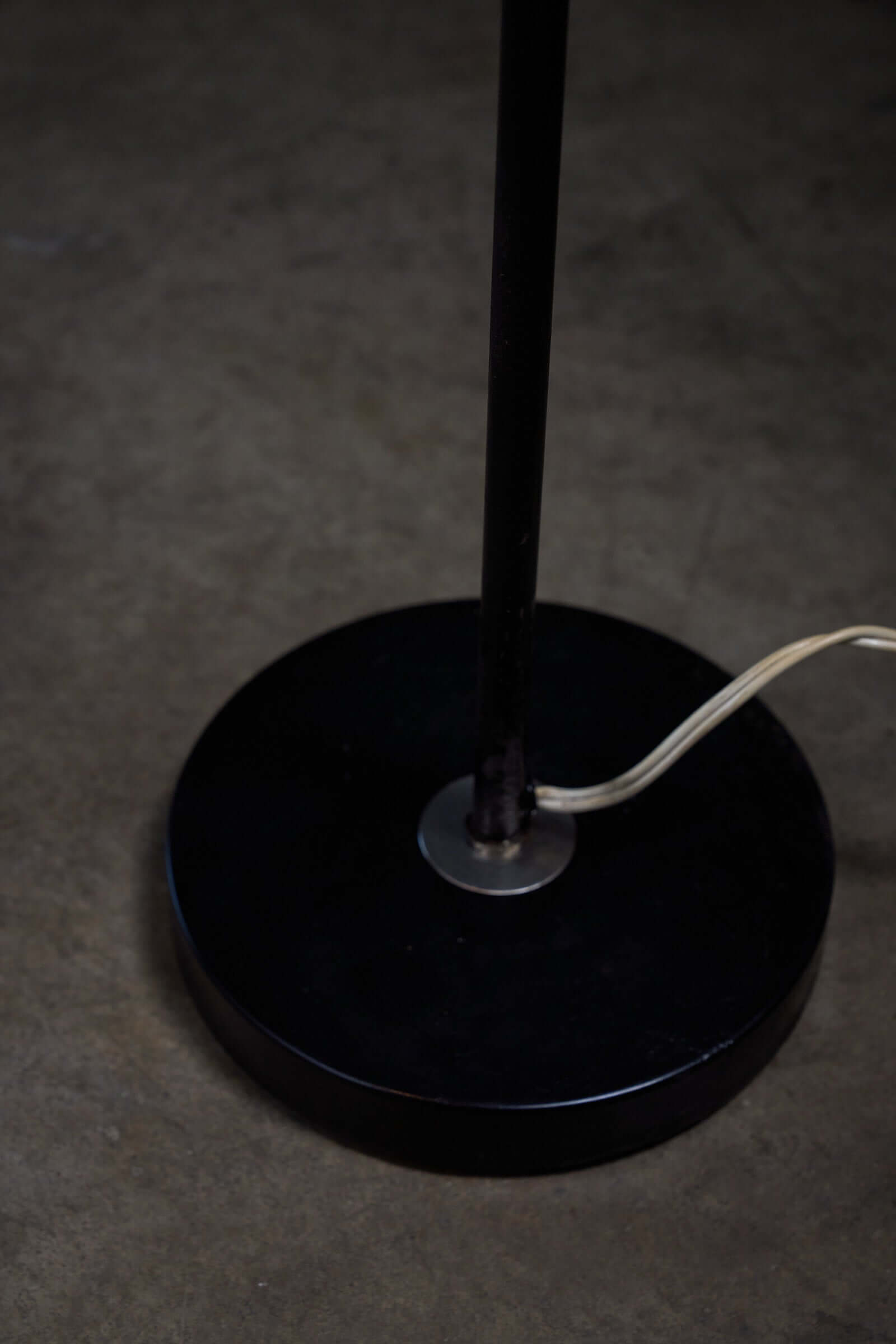 Floor lamp in black steel and copper shade, 1970s base detail showcasing the sleek design and elegance.