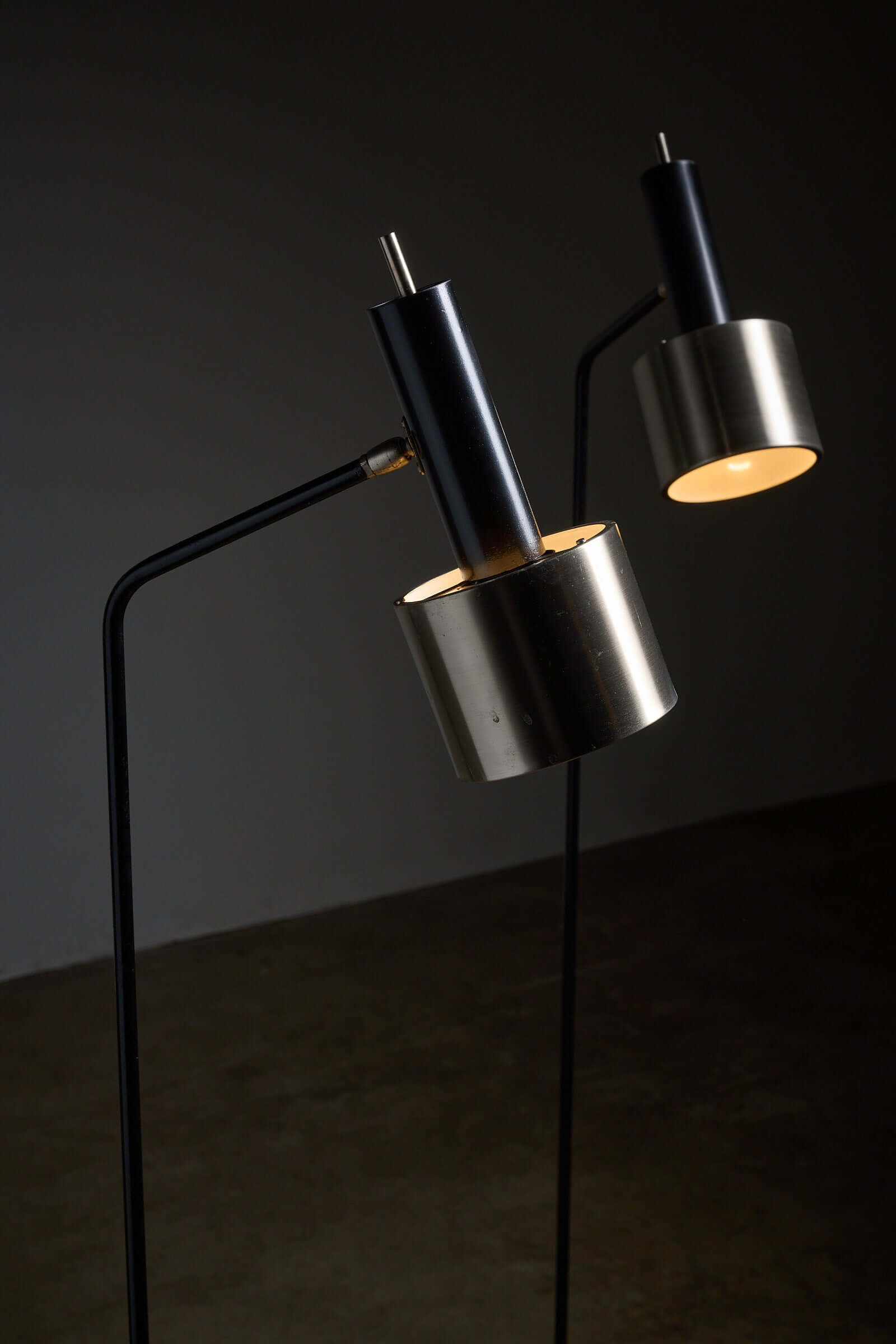 Pair of floor lamps in black metal with brushed aluminum shades, 1970s, showcasing modernist design and elegance.