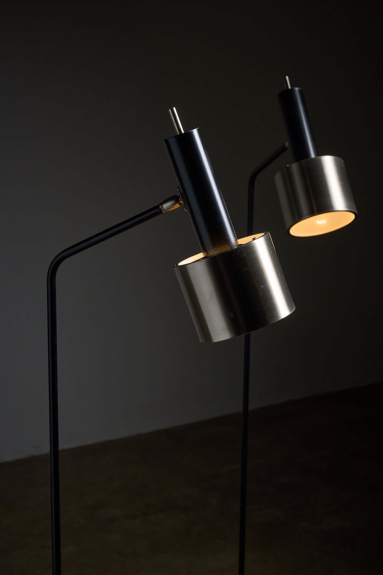 Pair of floor lamps in black metal with brushed aluminum shades, 1970s showcasing minimalist design.