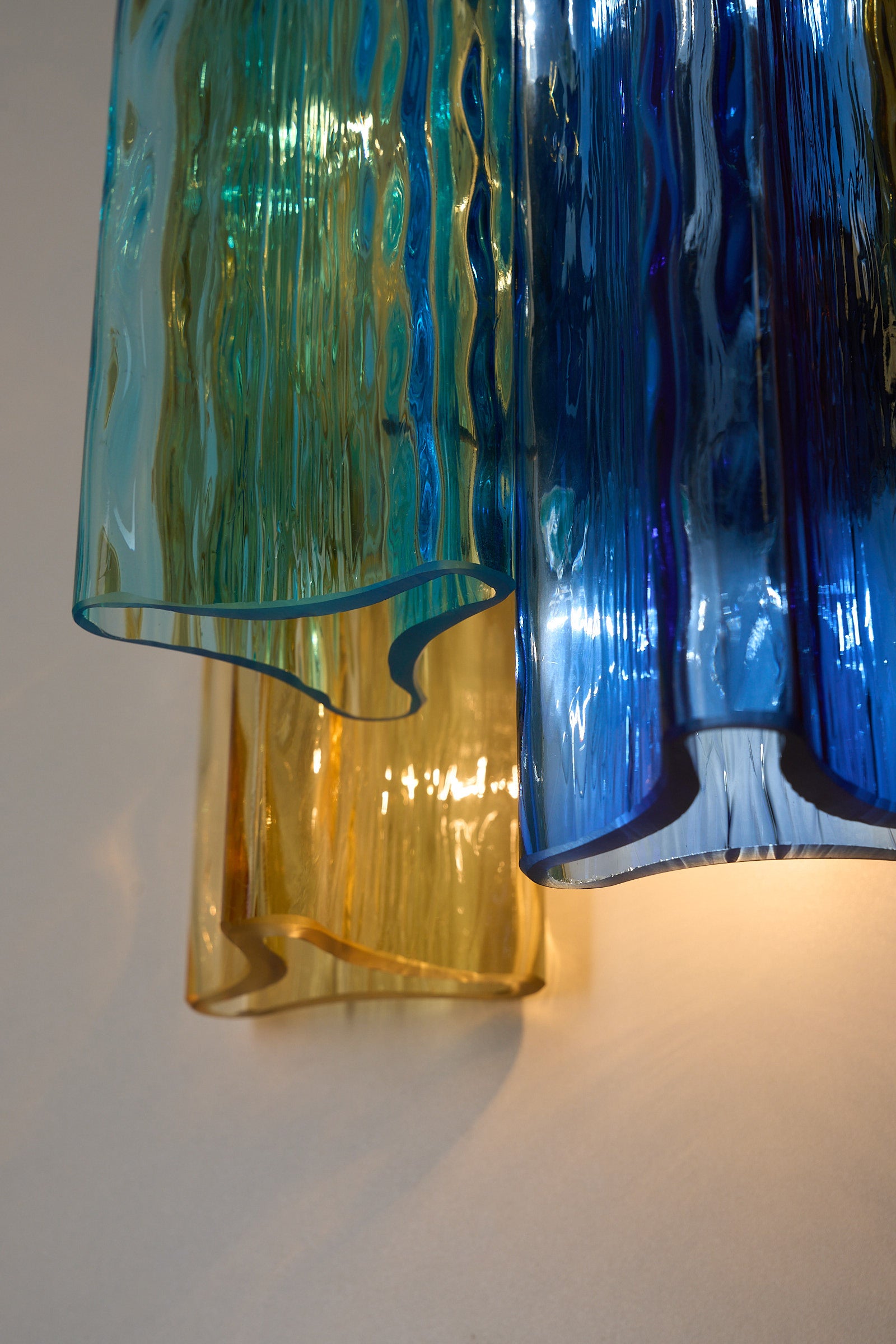 Unique pair of multicolor Murano glass wall lamps by Salviati & Co., Italy, circa 1970s, showcasing blue, amber, and aqua tones.