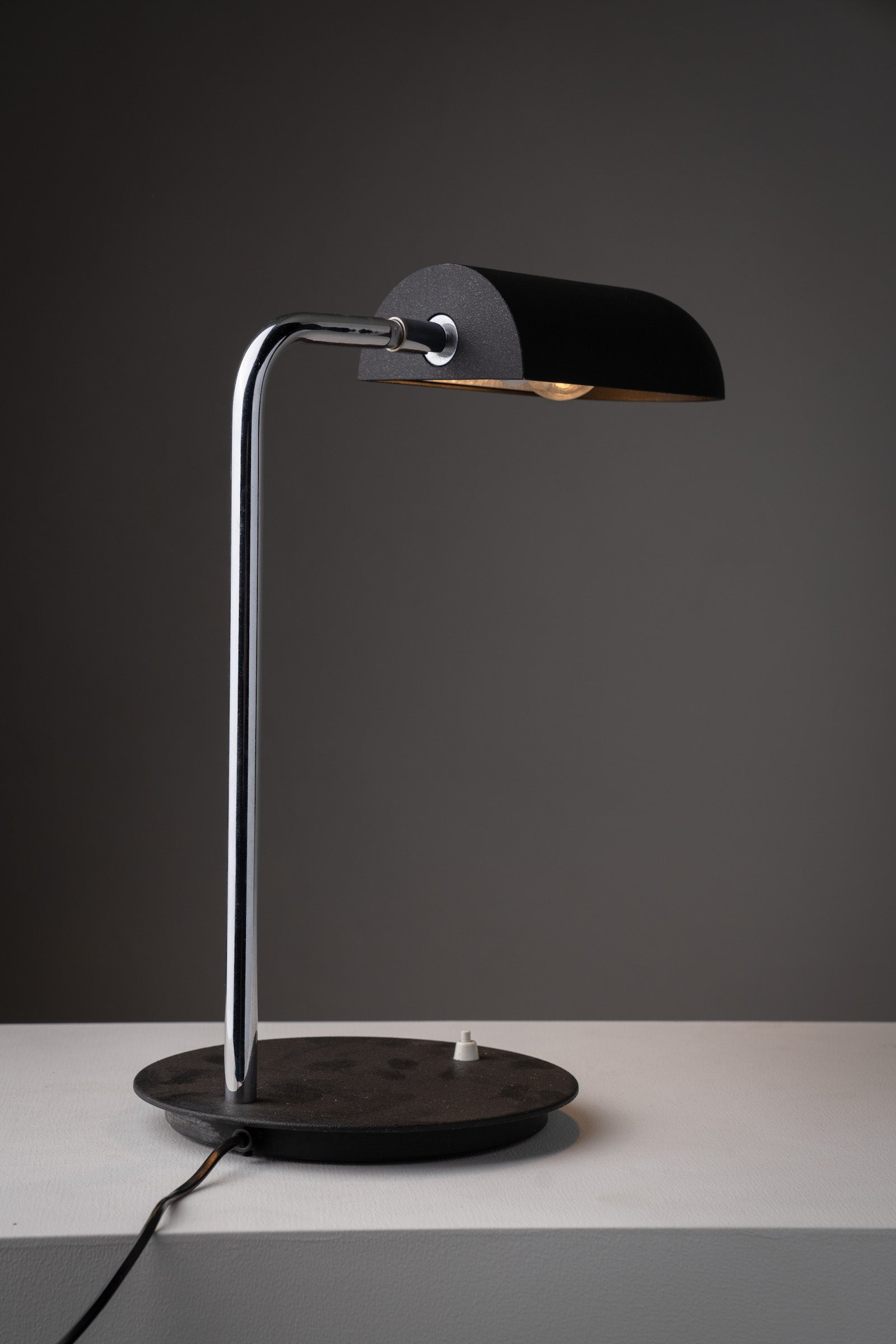 Adjustable "Snodo" table lamp by Sergio Mazza, Italy, 1970s with chrome stem and black lacquer shade.