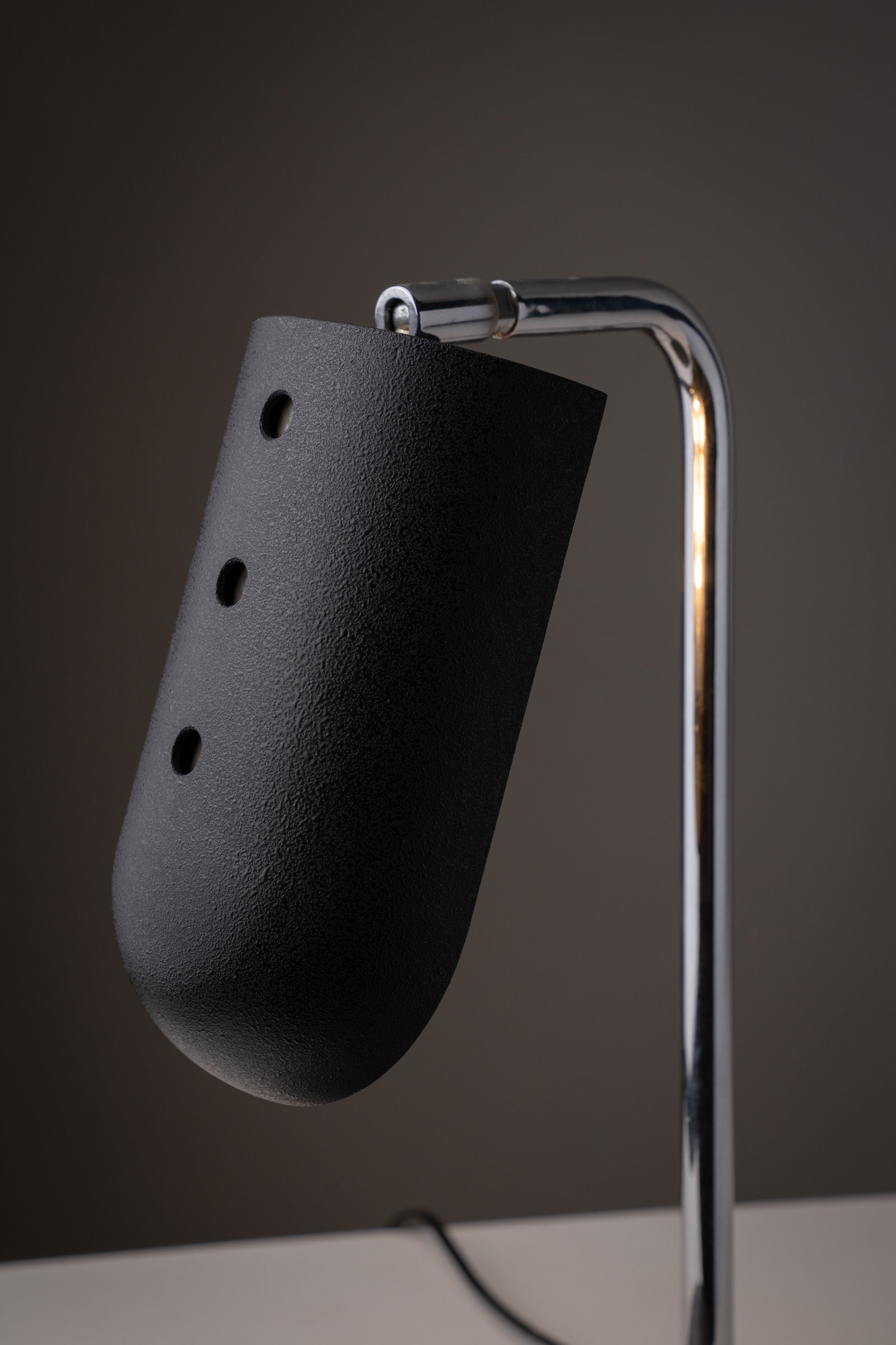 "Snodo" table lamp by Sergio Mazza, Italy, 1970s showcasing its black lacquer shade and chromed metal stem.