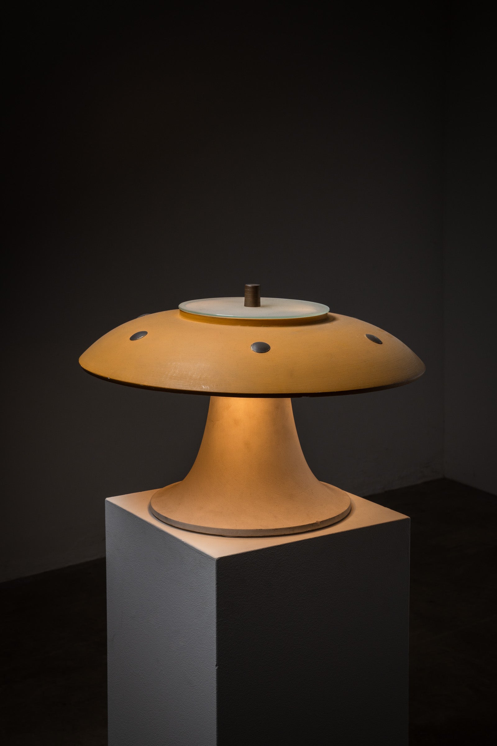 Huge Vintage Mushroom Table Lamp, 1960s showcased on a pedestal, featuring a yellow shade and white base.