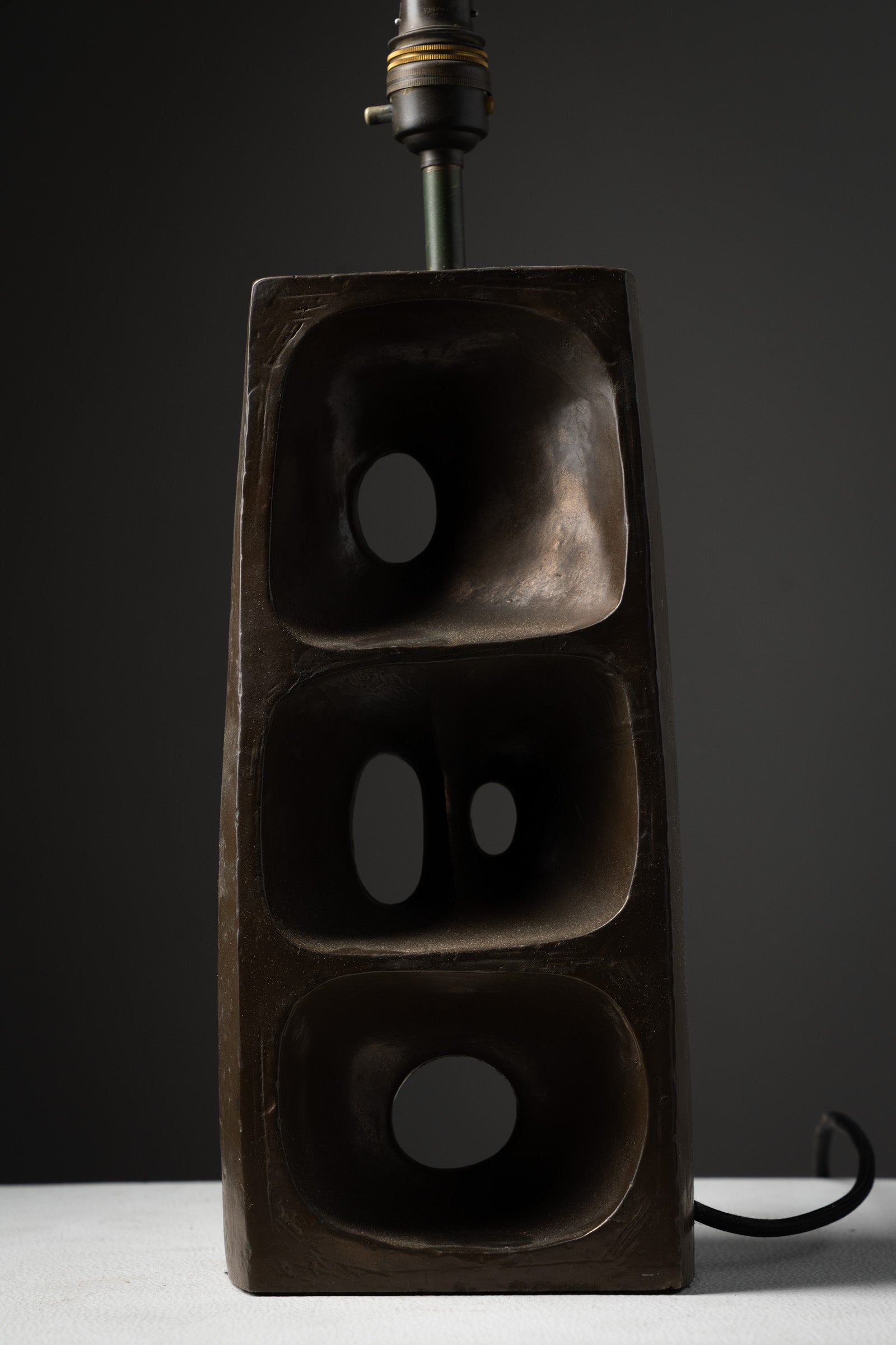 Brutalist Ceramic Table Lamp, 1970s with a textured geometric ceramic base and distinctive open forms.