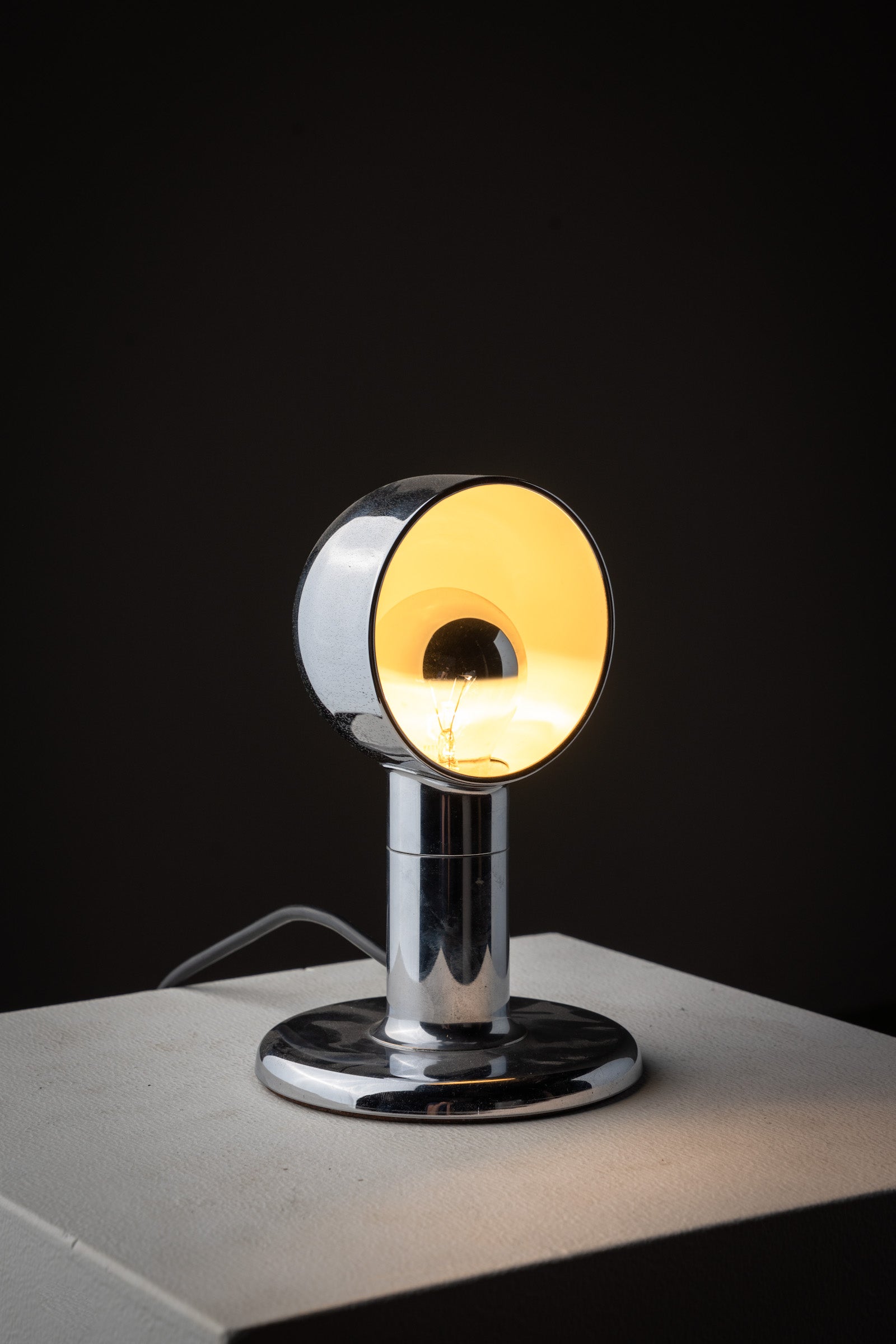 Small Space Age Chrome Table Lamp, 1970s illuminating a warm glow with a sleek reflective design.