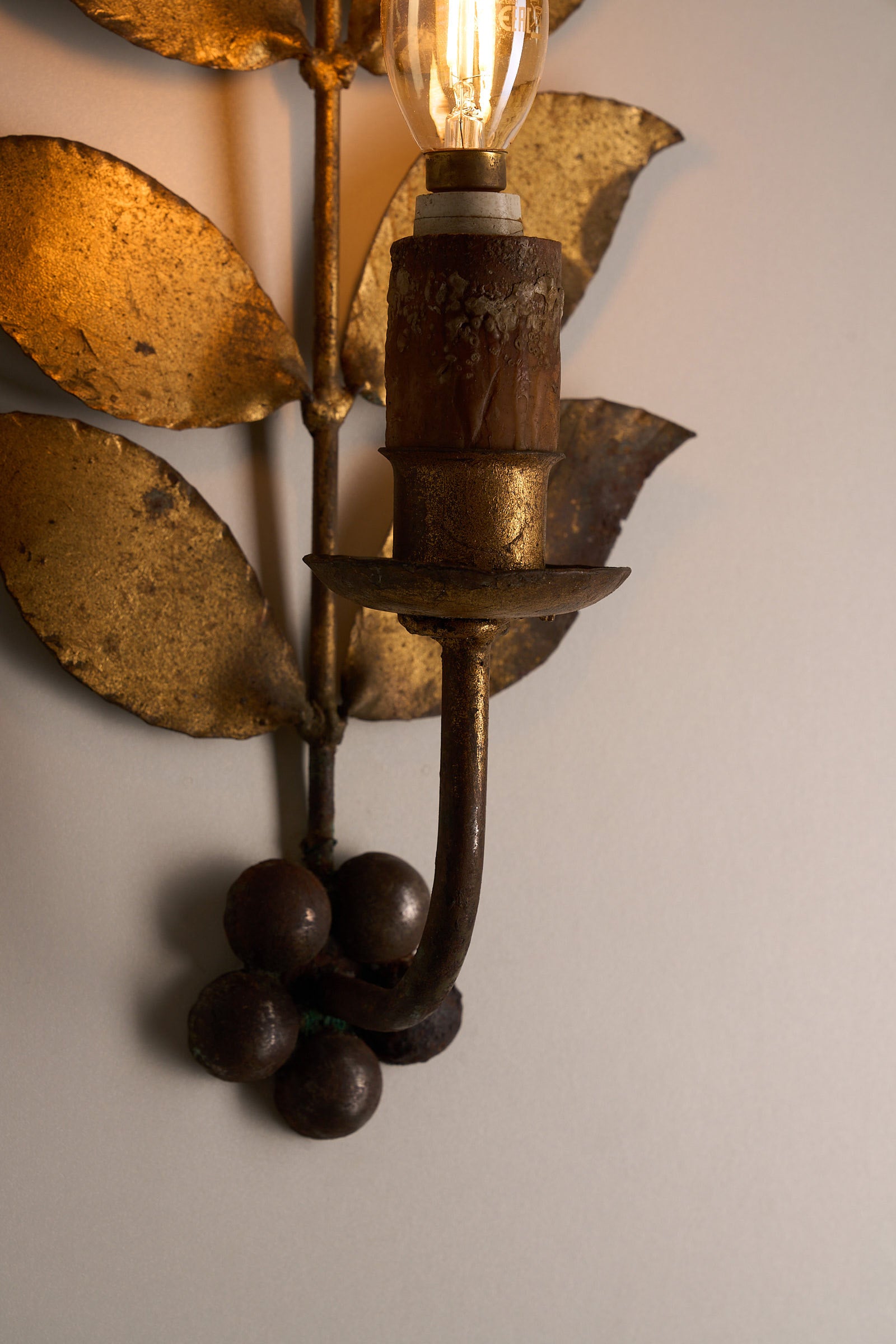 Brass Leaf Wall Sconce, 1920s with hand-shaped brass leaves and a vintage-style bulb.