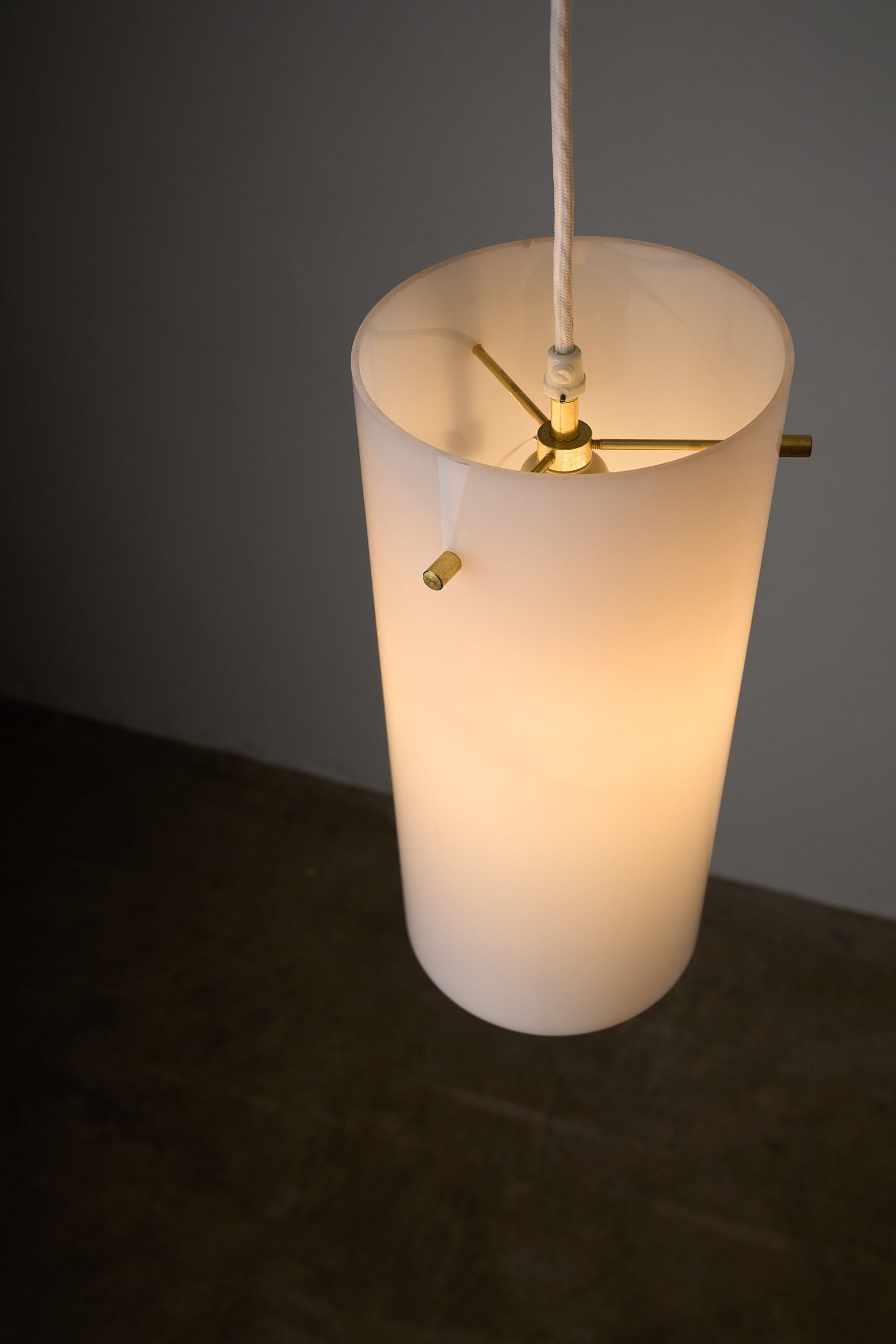 Tubular Acrylic Ceiling Lamp by Fog & Mørup, Denmark, 1960s hanging from the ceiling with a light illuminating the acrylic shade.