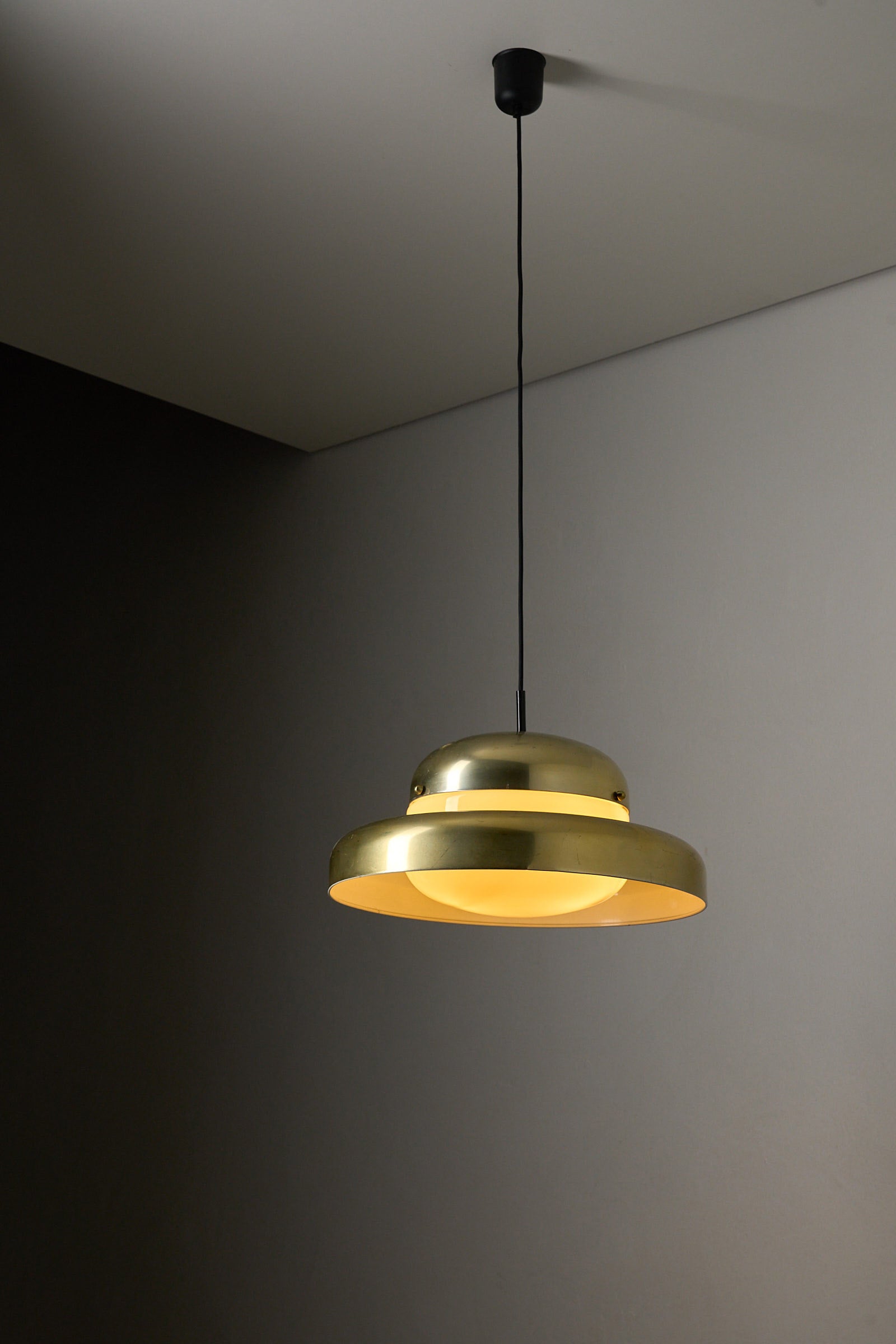 Large Brass and Yellow Glass Pendant illuminating a modern space with soft yellow light and sculptural design.