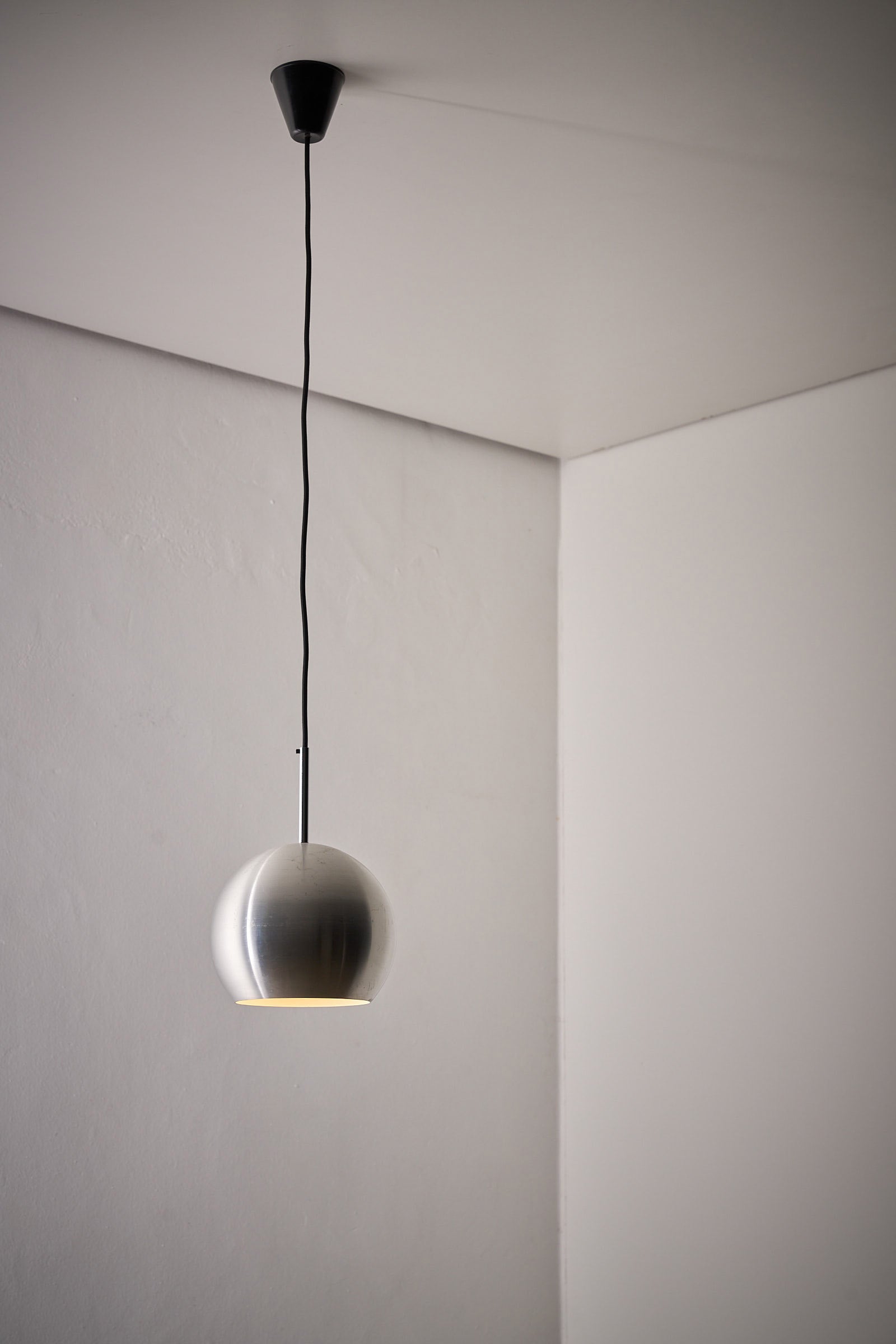 Brushed Aluminium Sphere Pendant by Cosack, Germany, 1960s hanging in a minimalist interior.