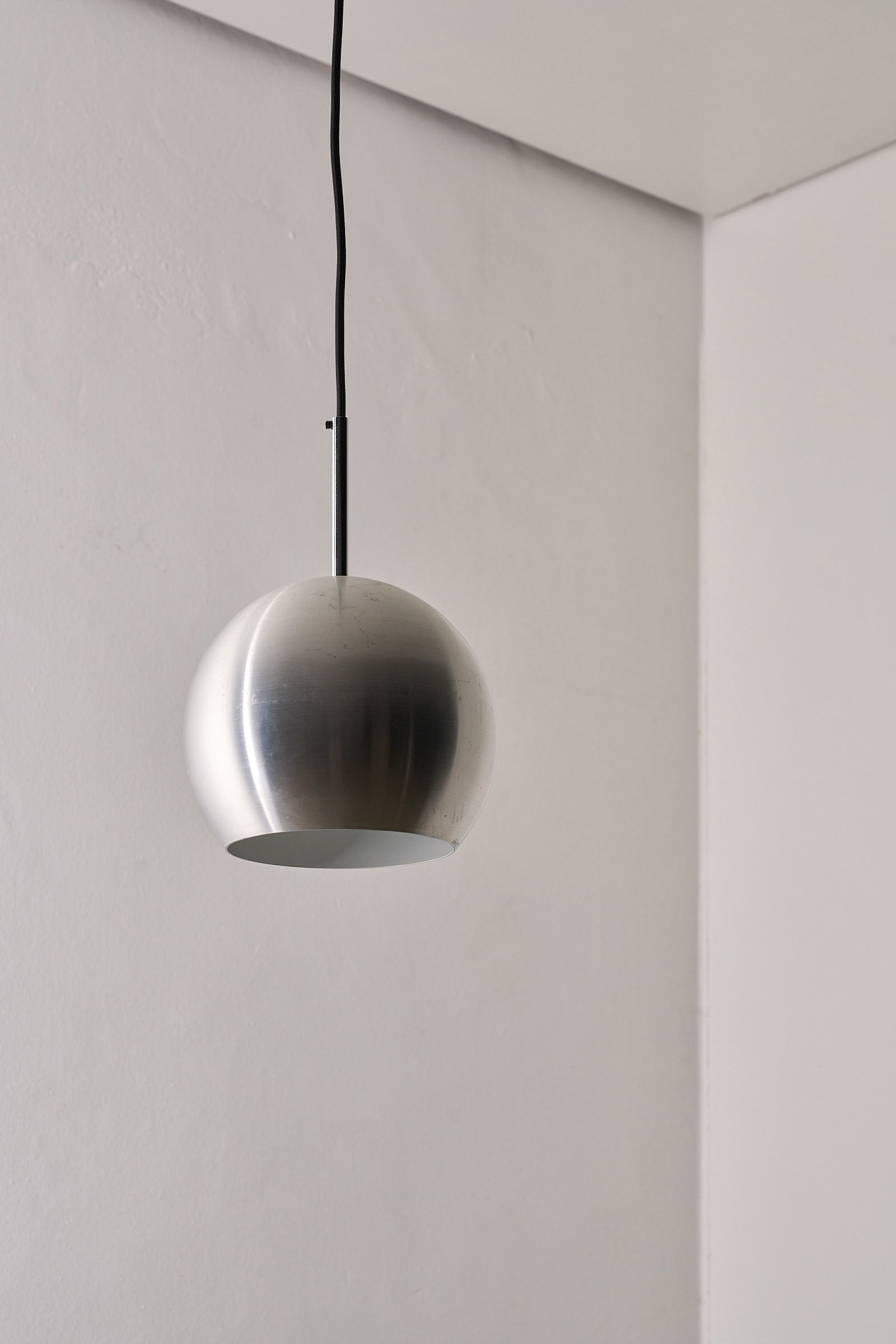 Brushed Aluminium Sphere Pendant by Cosack, Germany, 1960s hanging in a minimalist interior with a clean design.