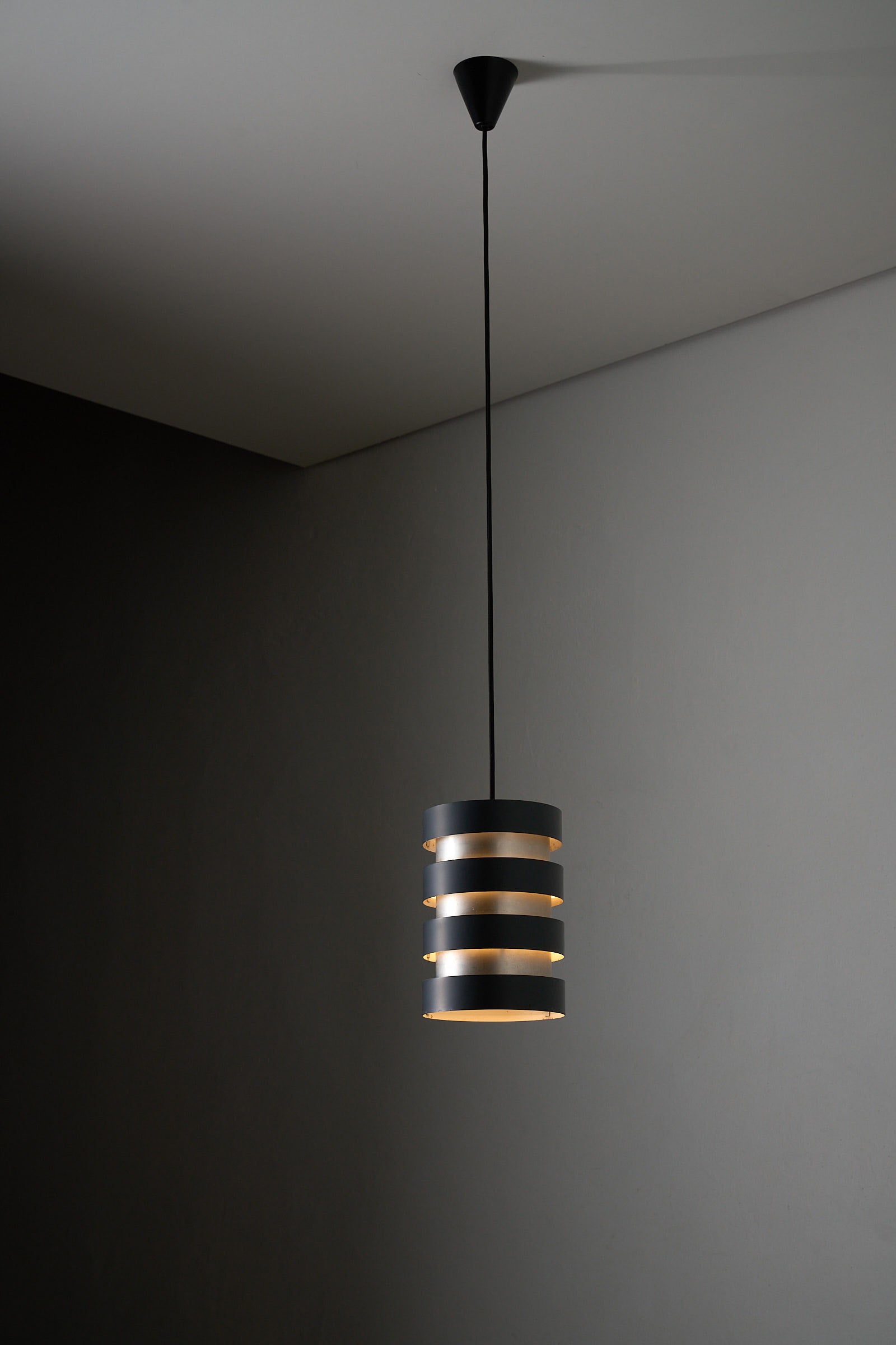 Fog & Mørup “Eiffel” Pendant by Jo Hammerborg, Denmark, 1960s featuring a striking design of cylindrical aluminium shade.