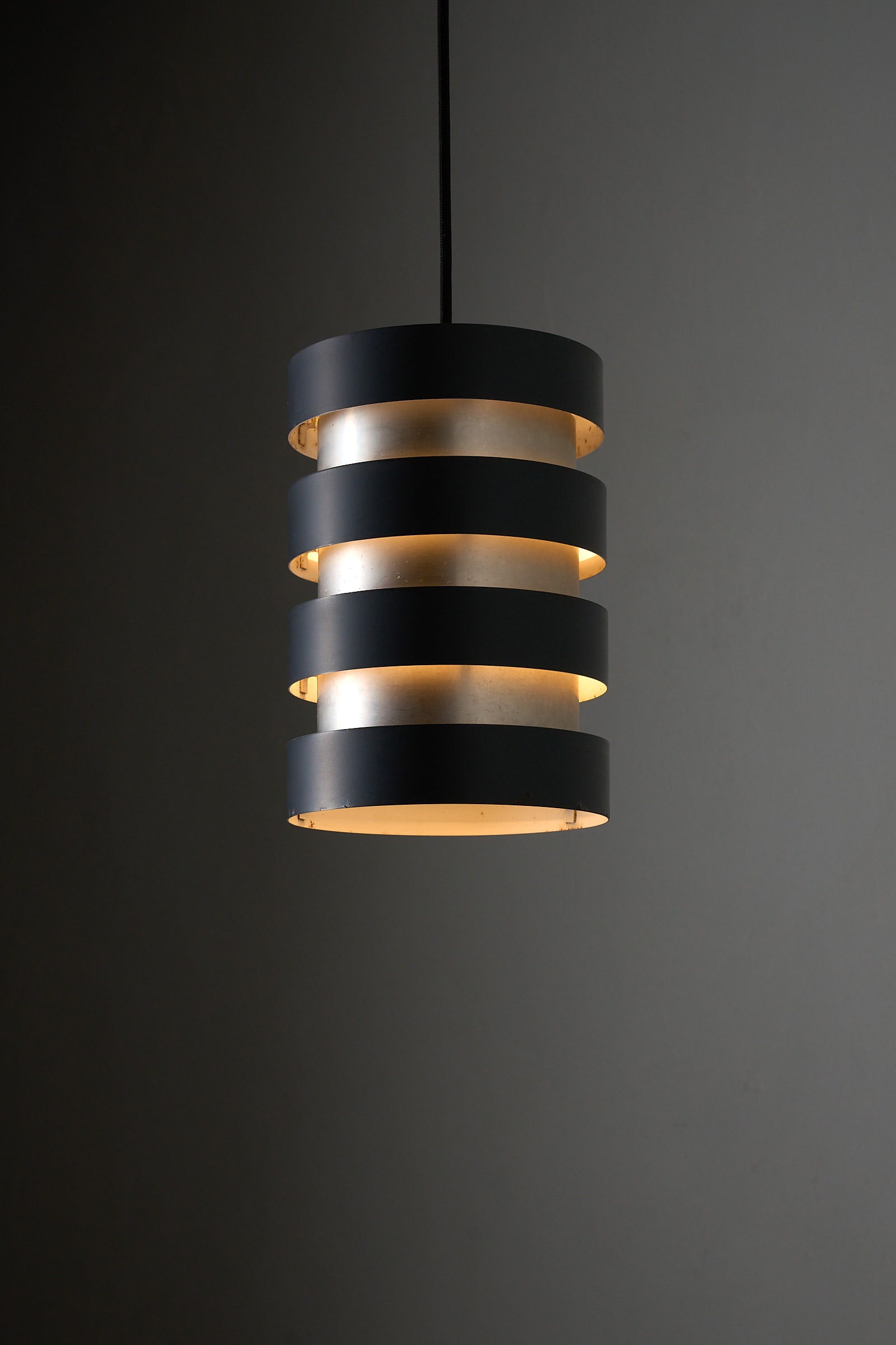 Fog & Mørup “Eiffel” Pendant by Jo Hammerborg, Denmark, 1960s, featuring a cylindrical shade with black and brushed aluminium.