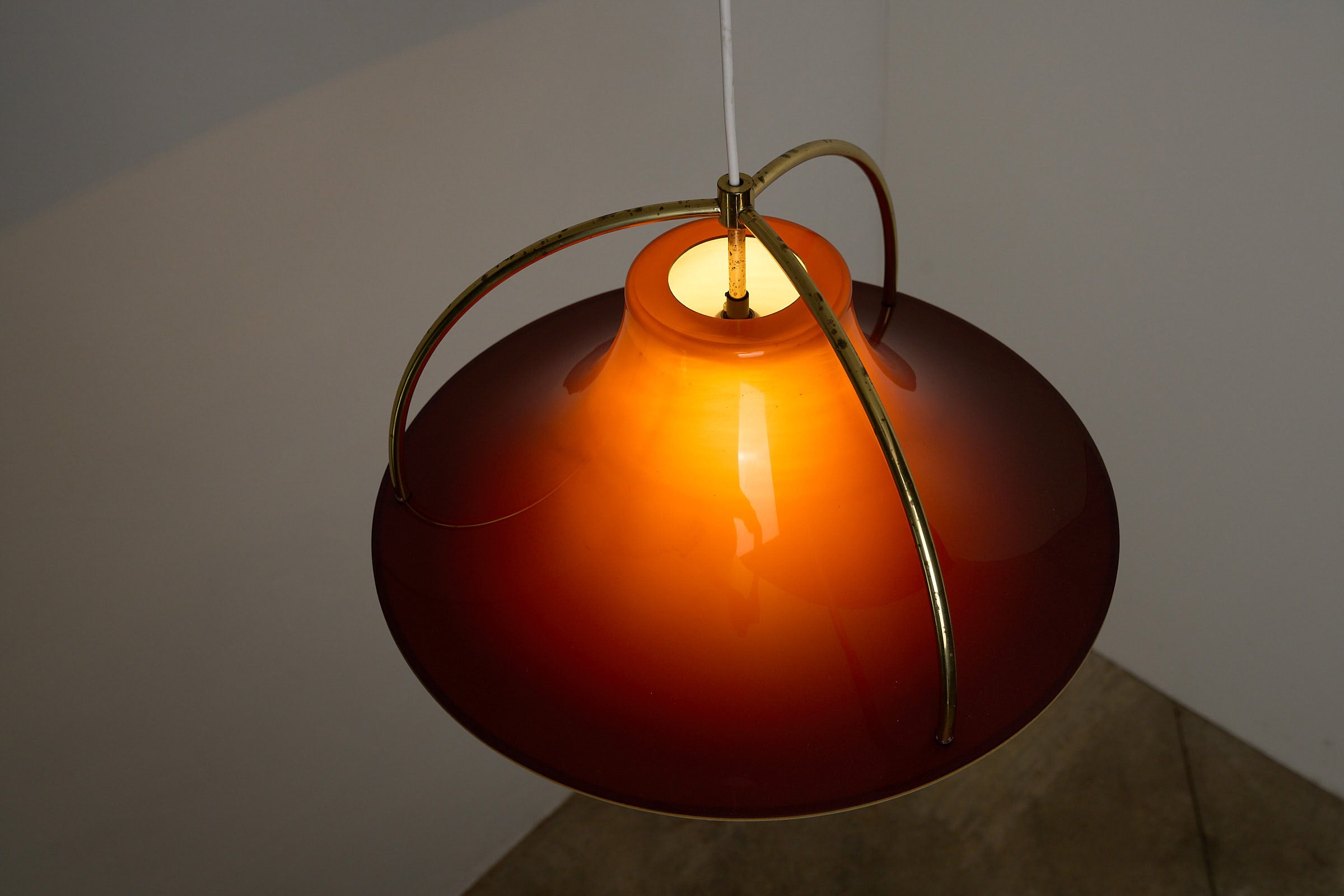 Fog & Mørup “Single” Pendant Lamp by Jo Hammerborg, 1970s with warm caramel tones and brass arches.