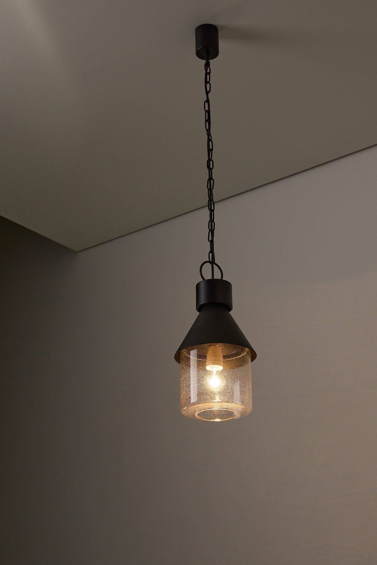BOOM Ceiling Lamp, Black Metal & Bubble Glass Pendant showcasing warm glow and industrial elegance.