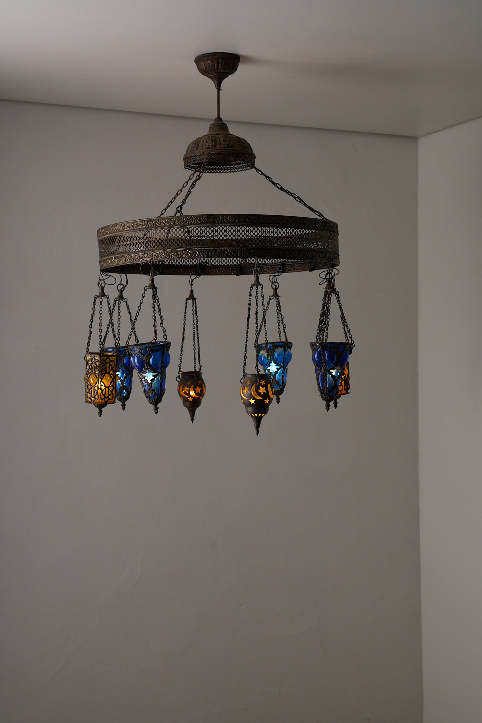 Moroccan Chandelier with Six Colored Glass Pendants showcasing intricate brasswork and vibrant colored glass lamps.