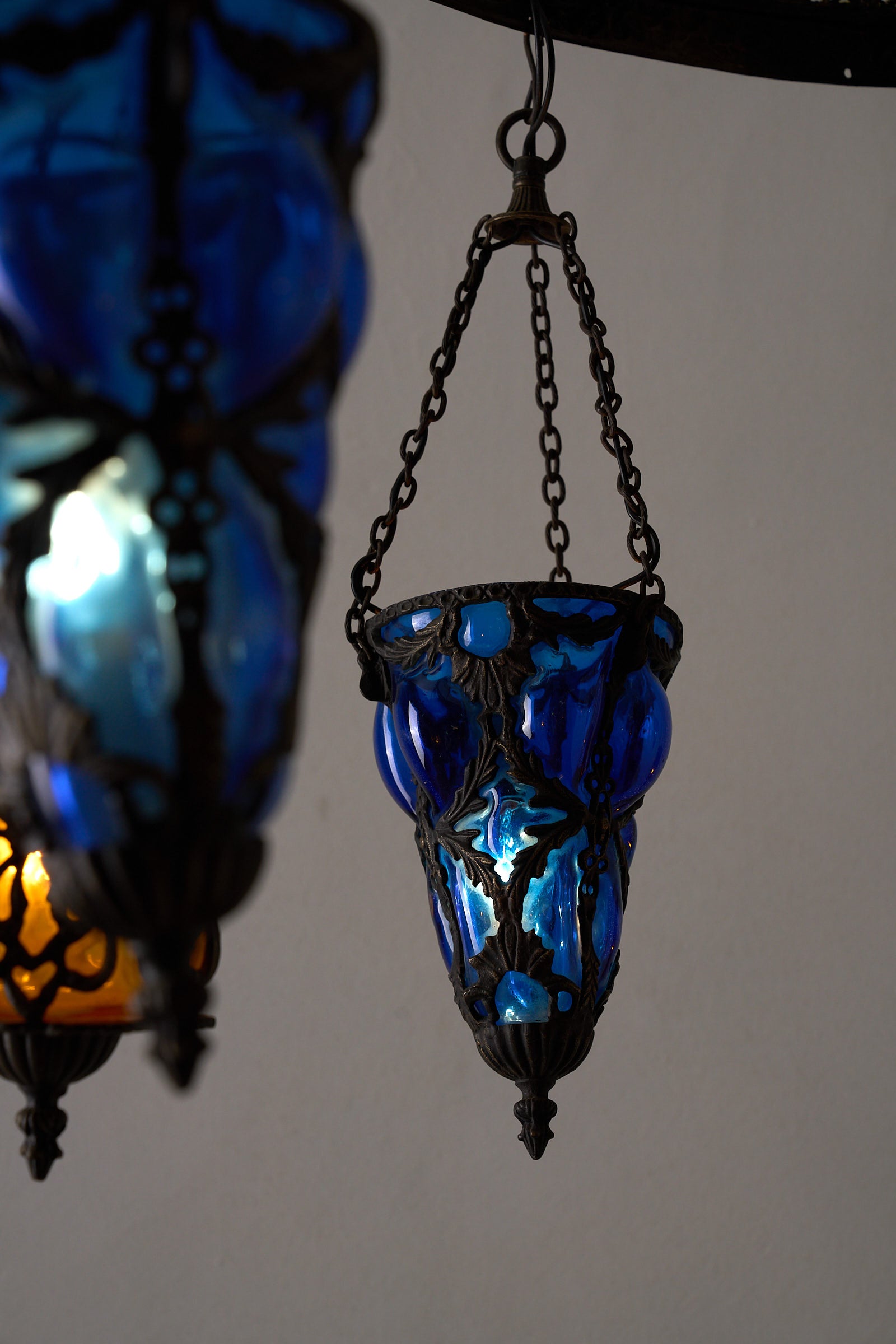 Moroccan Chandelier with Six Colored Glass Pendants showcasing a vivid blue glass lantern pendant.