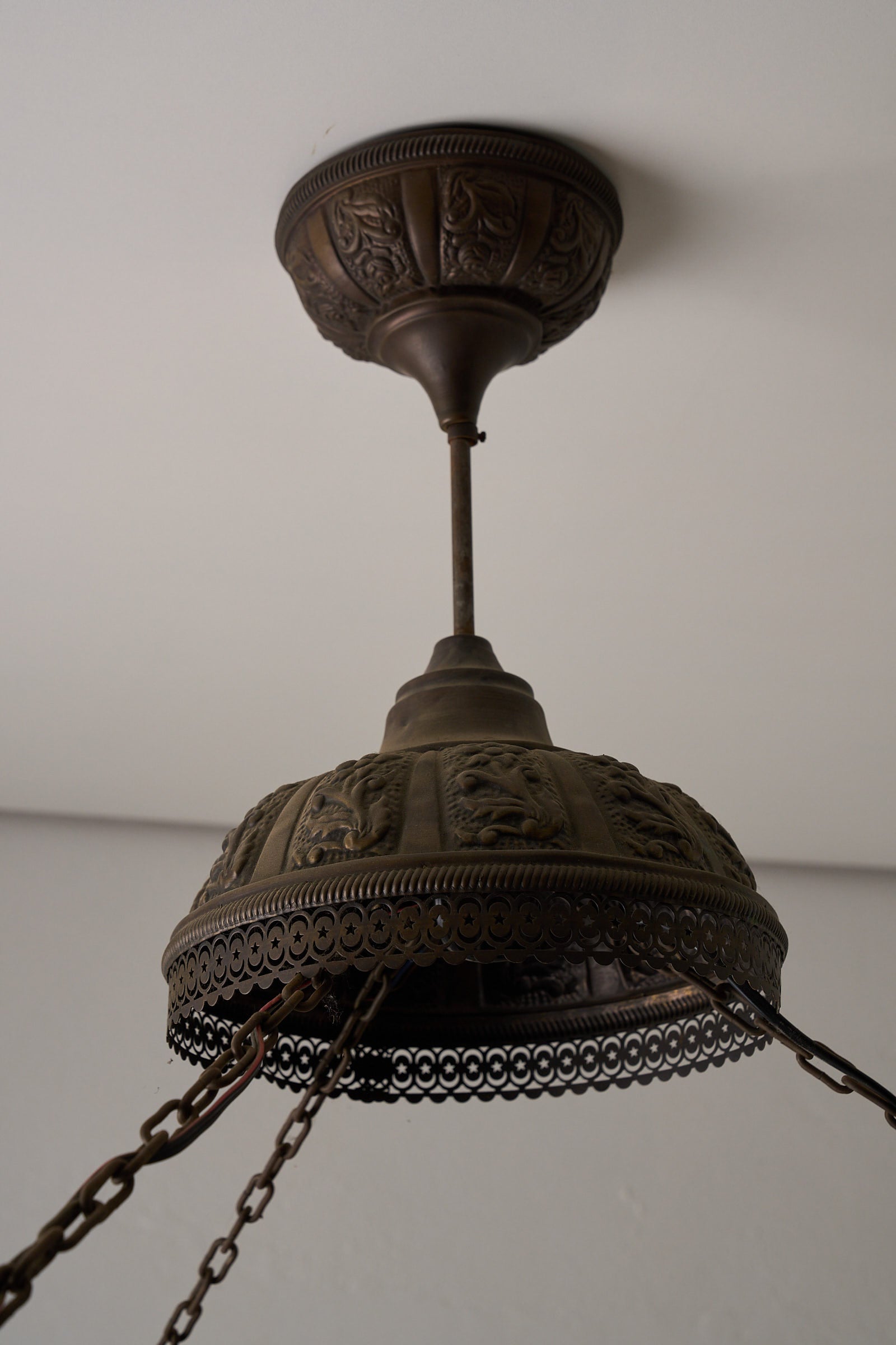 Moroccan Chandelier with Six Colored Glass Pendants showcasing intricate brasswork and detailed metal design from above.