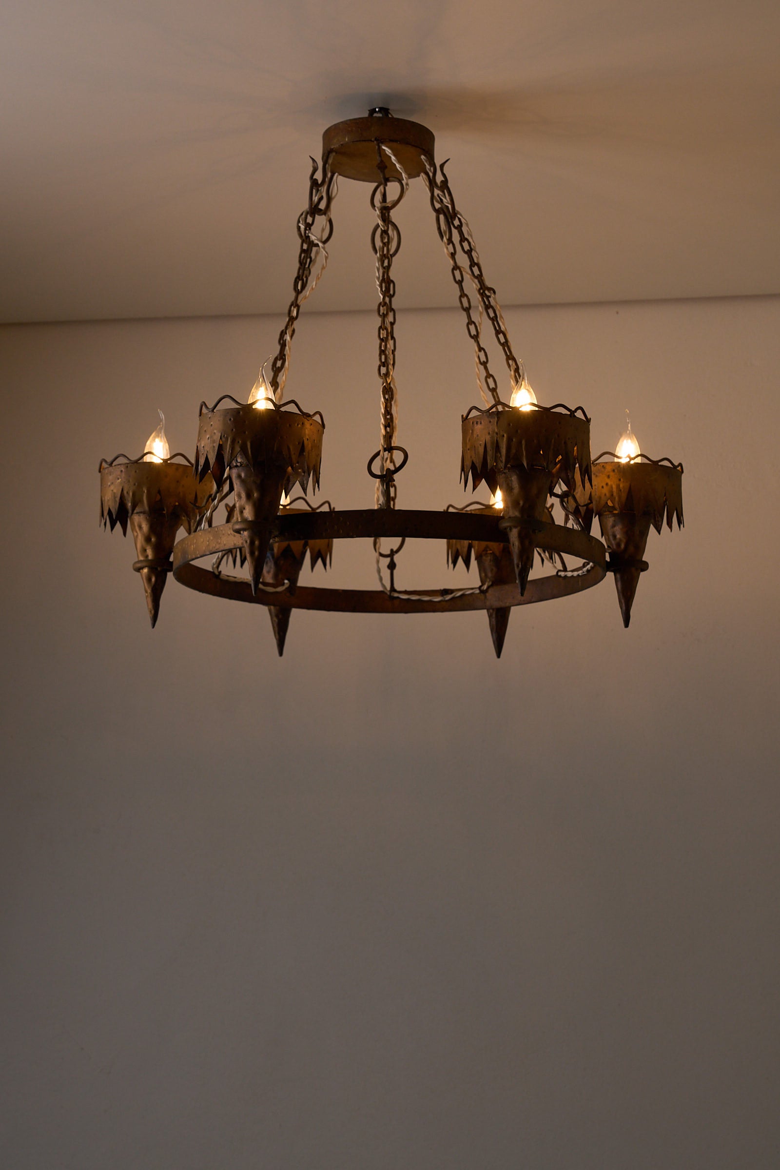 Wrought Iron Chandelier with Six Torch-Shaped Lights, 20th Century showcasing torch-like fittings and rustic design.
