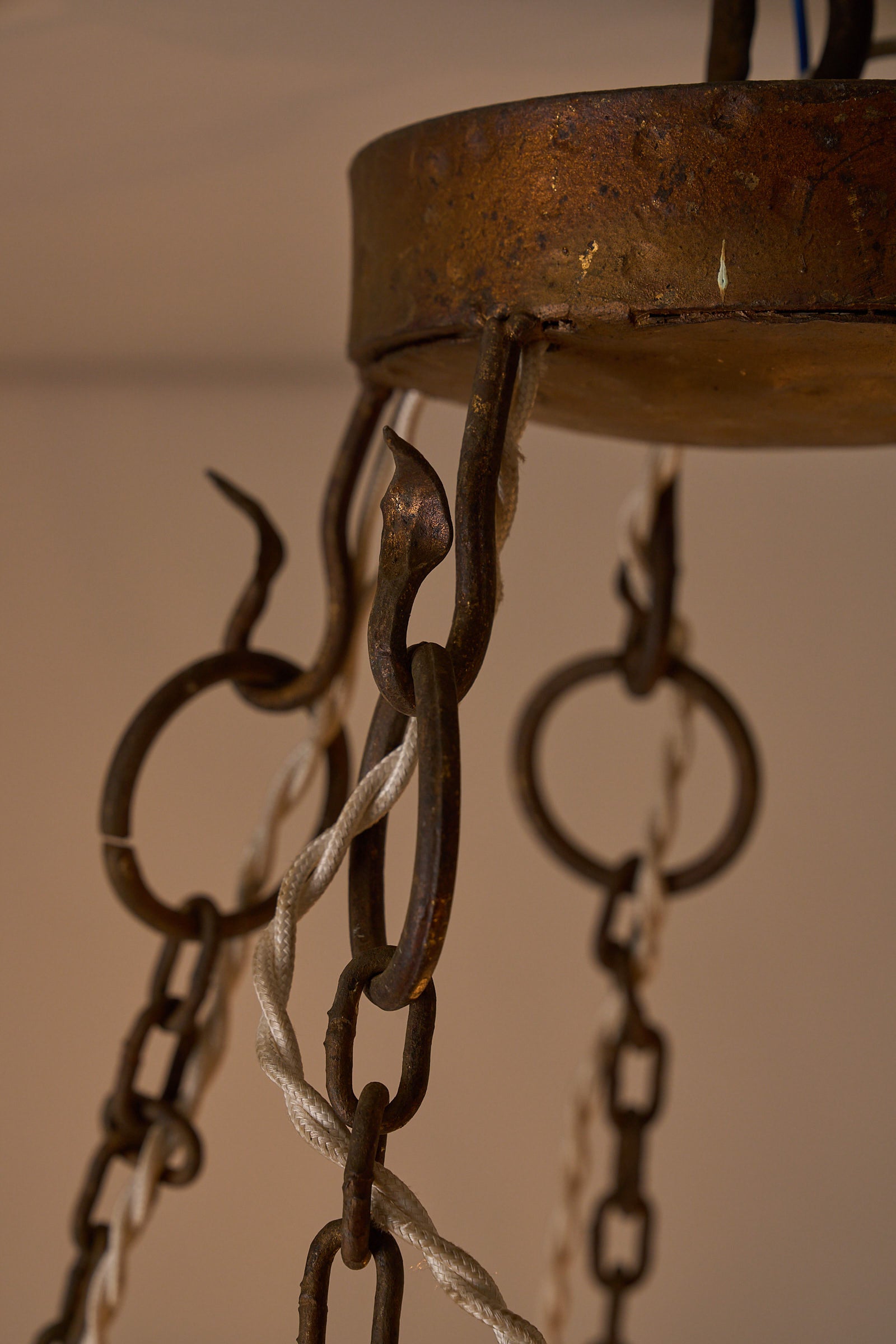 Wrought Iron Chandelier with Six Torch-Shaped Lights, 20th Century hanging chains and hooks close-up.