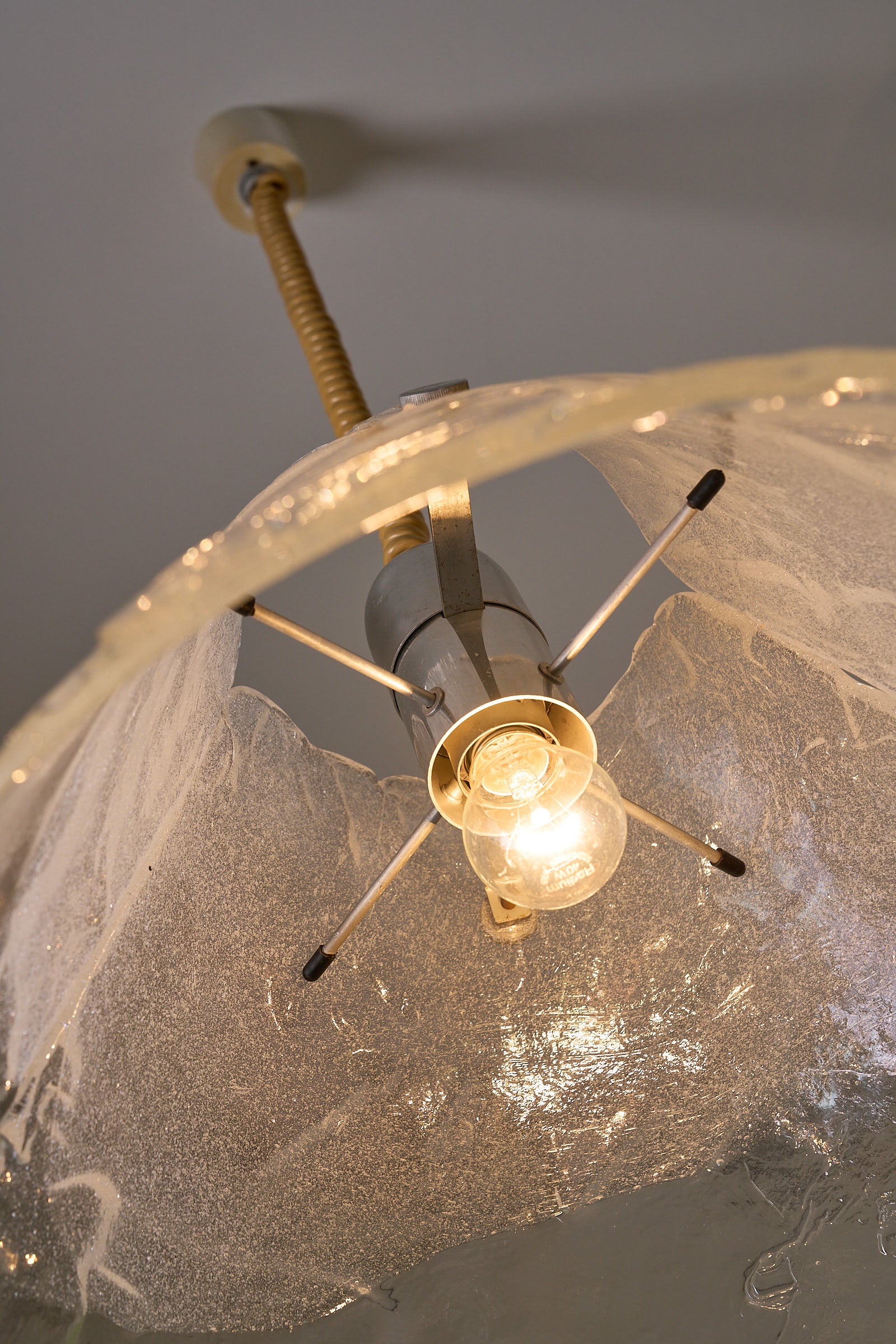 Carlo Nason Two-Panel Glass Chandelier with Murano glass and brass details, highlighting the conical shape and light bulb.