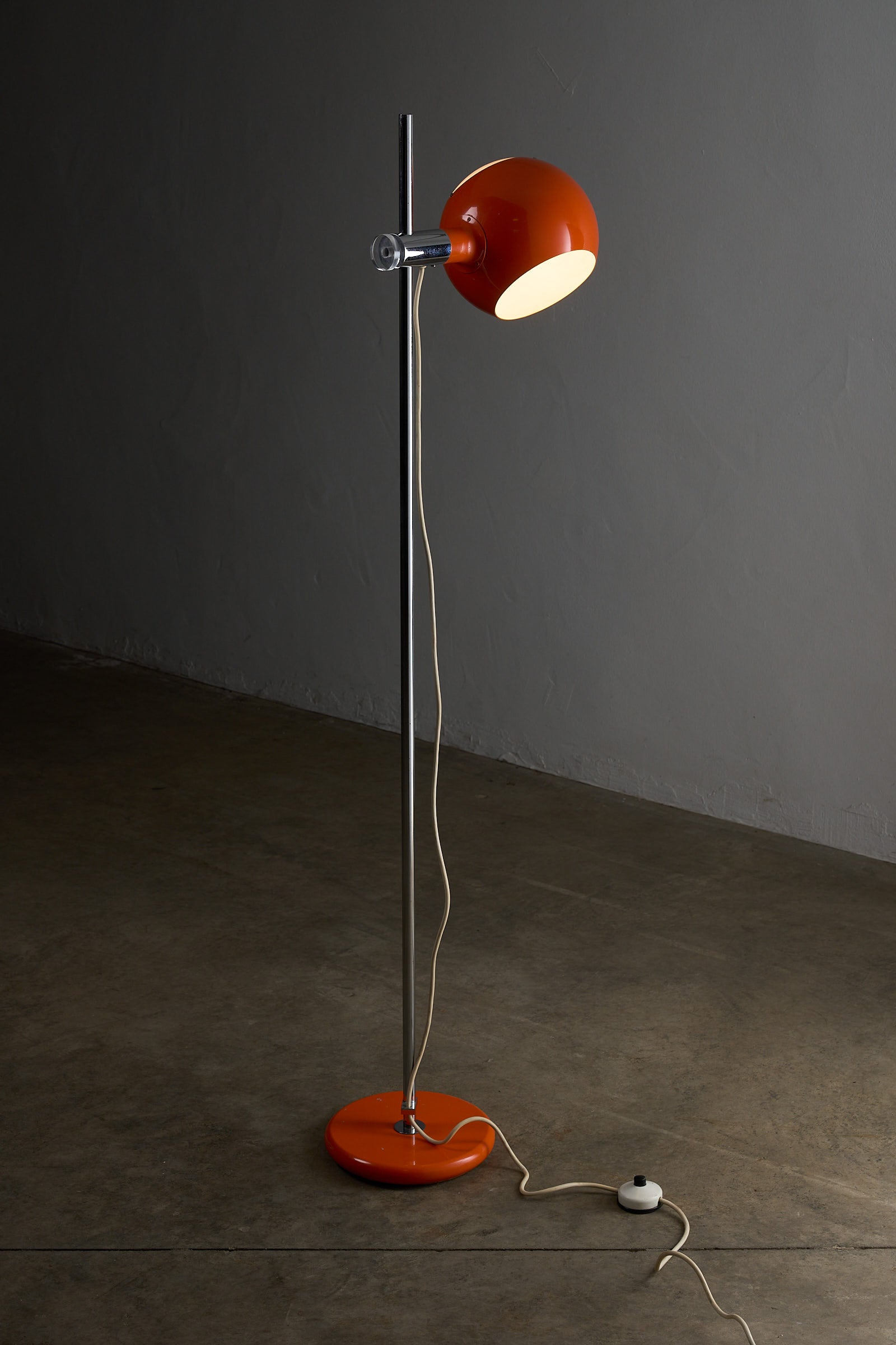 Orange Sphere Floor Lamp with Diffuser featuring a sleek chromed steel stem and an adjustable orange shade.
