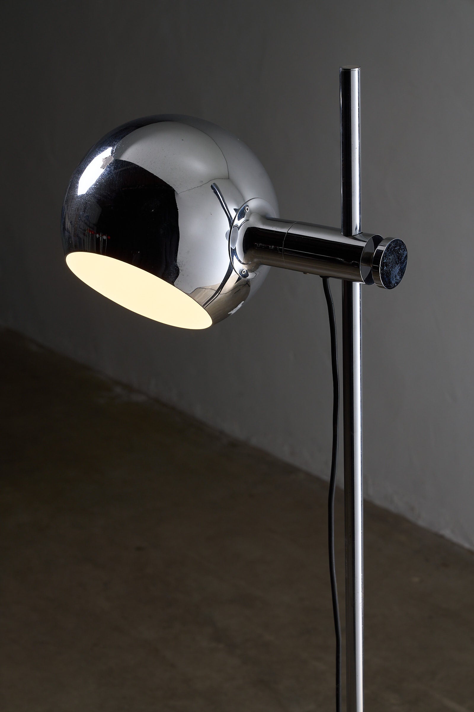 Chrome Sphere Floor Lamp with chromed steel sphere, adjustable shade, and chrome stem.