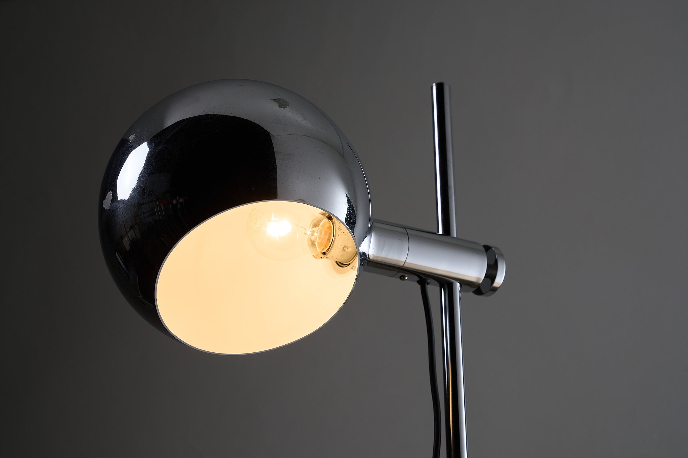 Chrome Sphere Floor Lamp featuring a rotatable chrome shade and adjustable height stem.