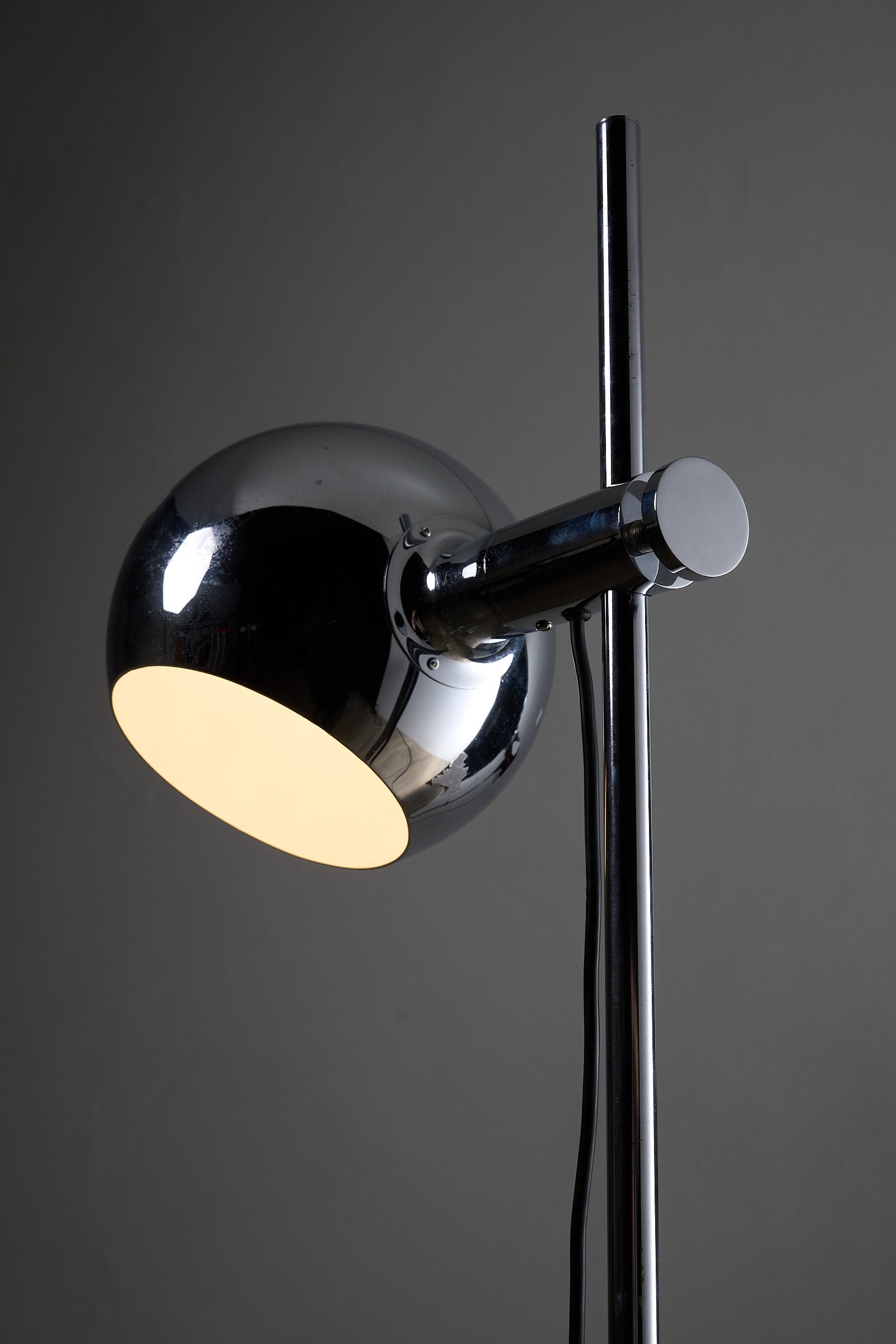 Chrome Sphere Floor Lamp featuring a chrome sphere shade and stem for adjustable lighting.
