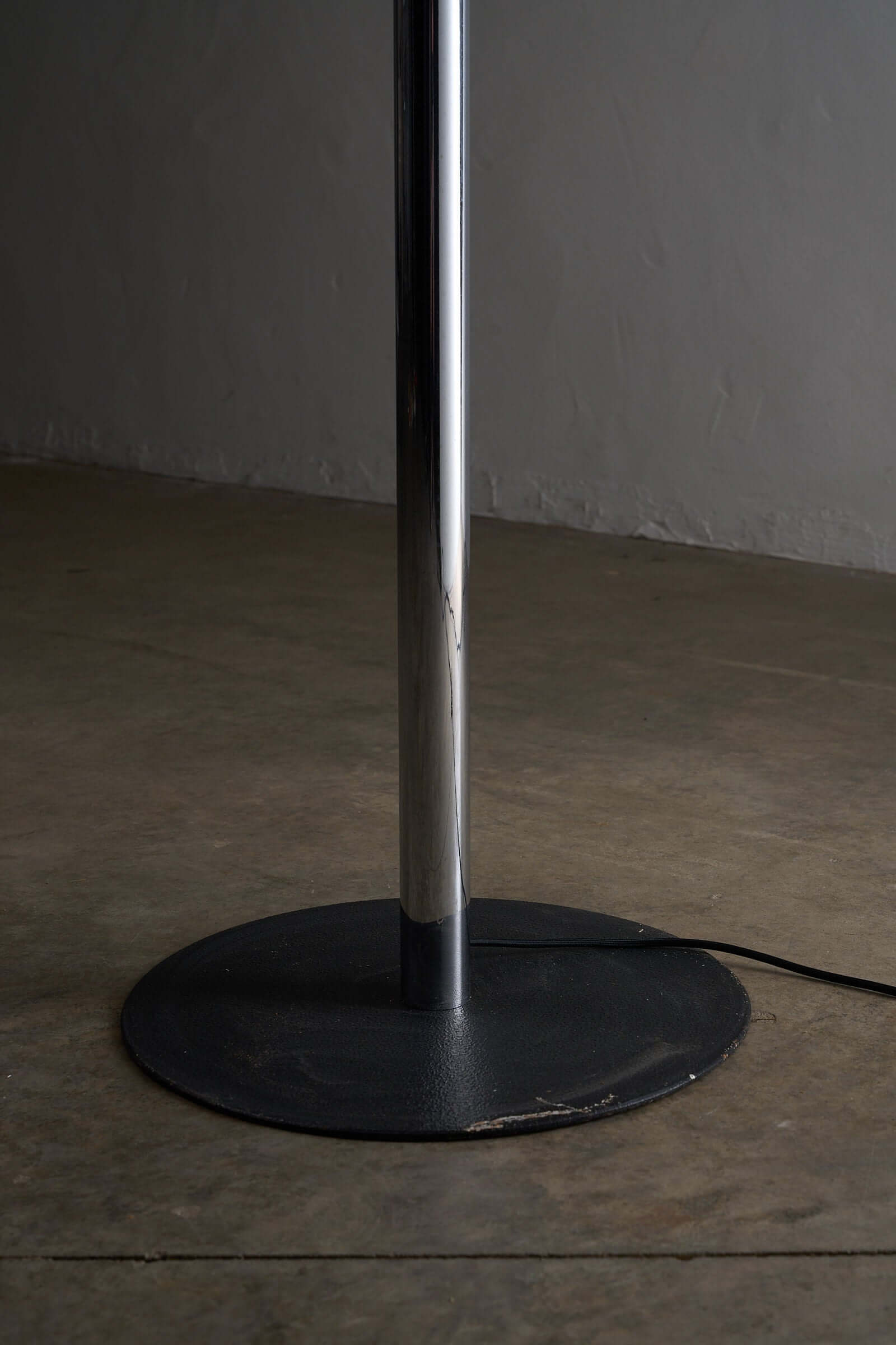 Close-up of the base and column of a Space Age Atomic Floor Lamp showcasing its chrome finish and stable design.