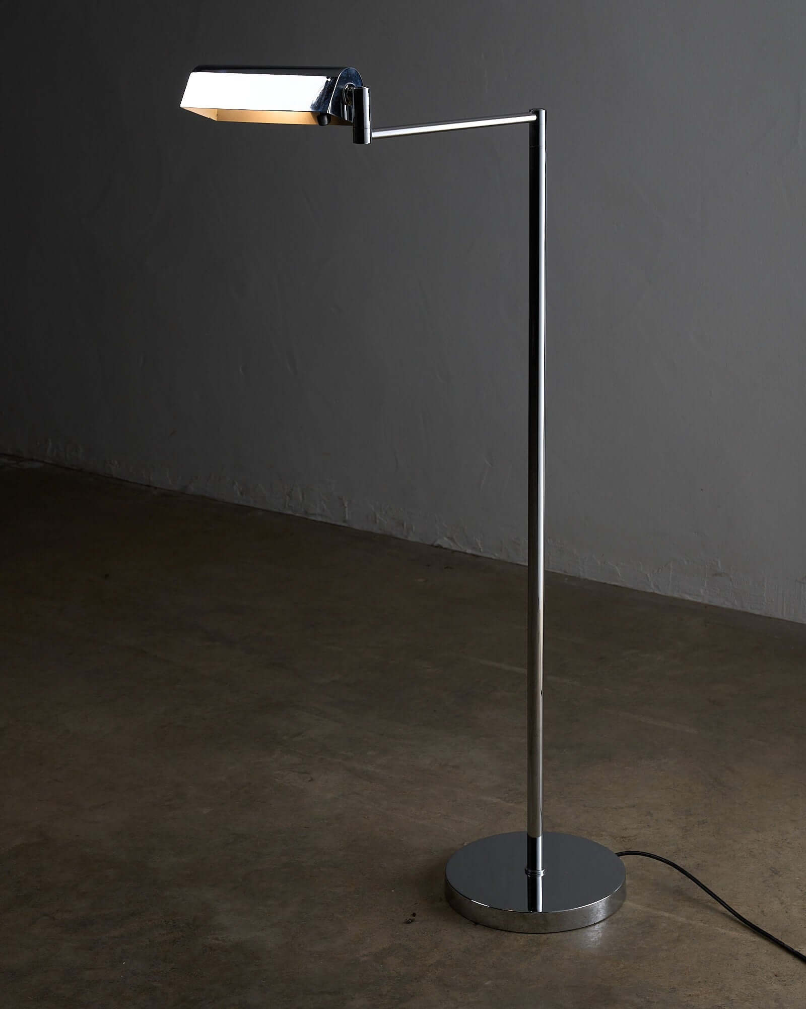 George Hanson Floor Lamp showcasing minimalist chrome design with a swing-arm feature.