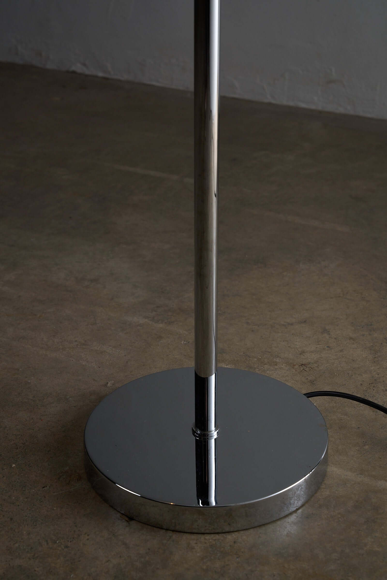 Base of the George Hanson Floor Lamp showcasing its minimalist chrome design and elegant geometry.