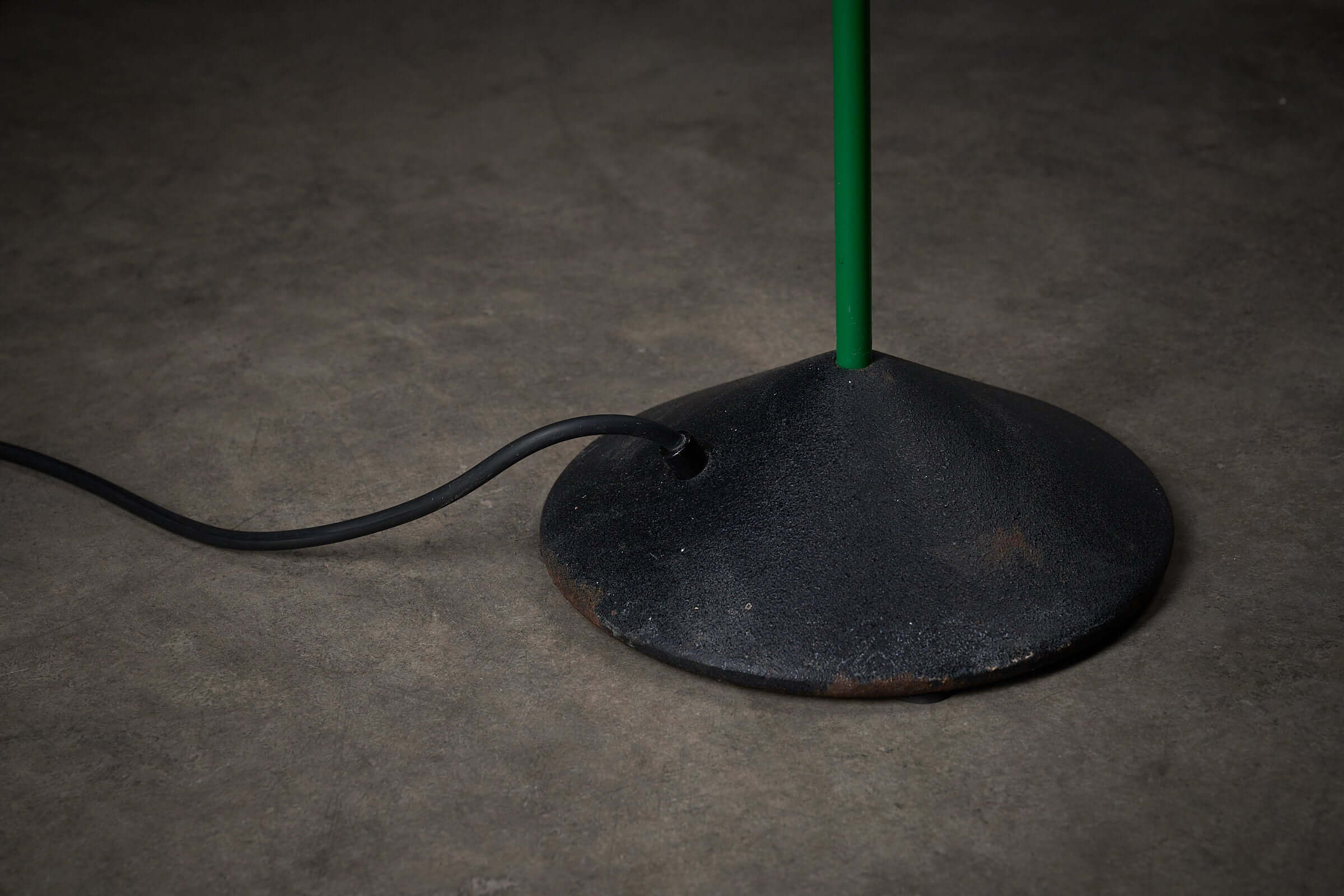 Green Floor Lamp By Raul Barbieri & Giorgio Marianelli base with black cord on a textured surface.
