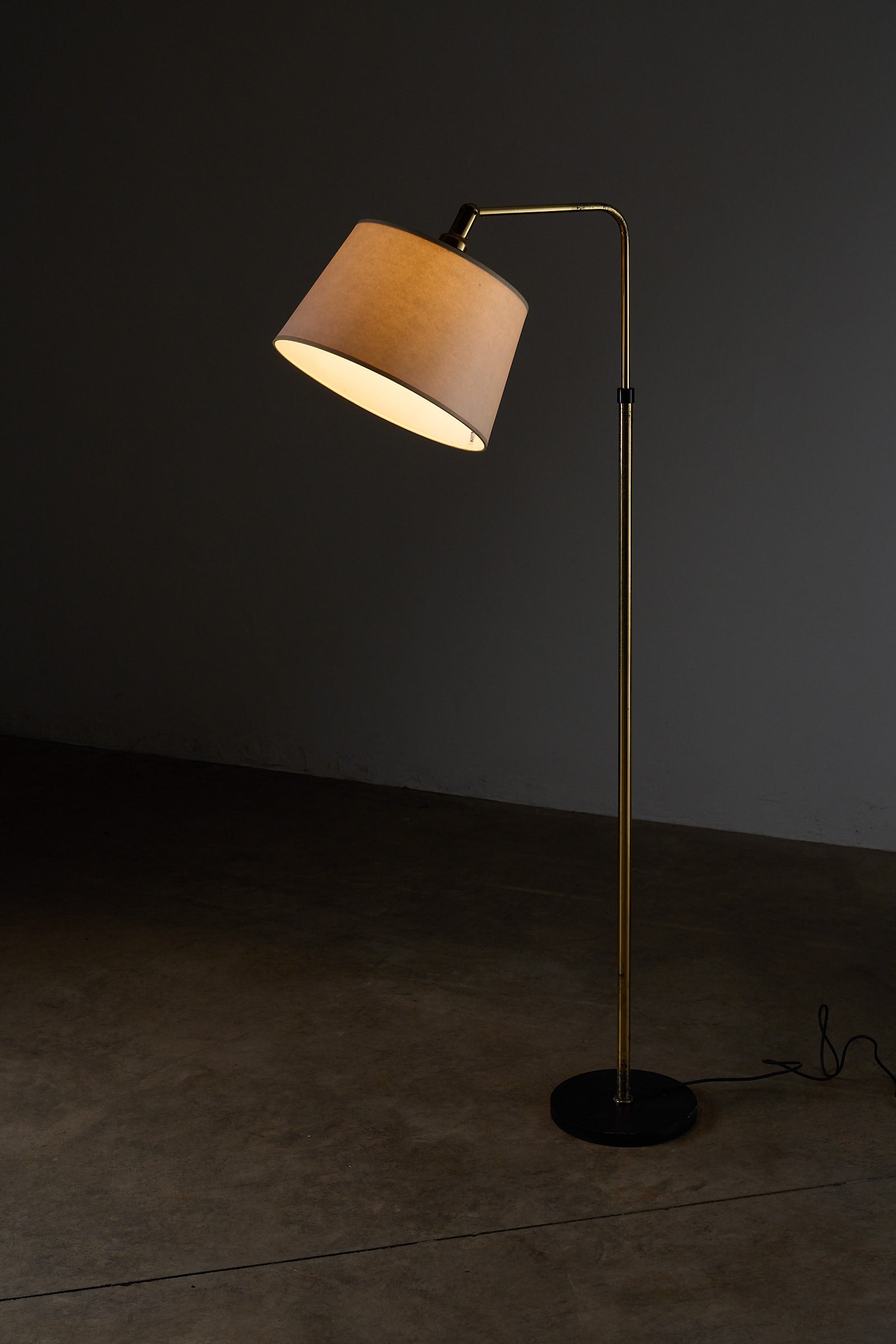 Adjustable Floor Lamp, Metalarte Spain with conical shade and brass stem in a stylish setting.