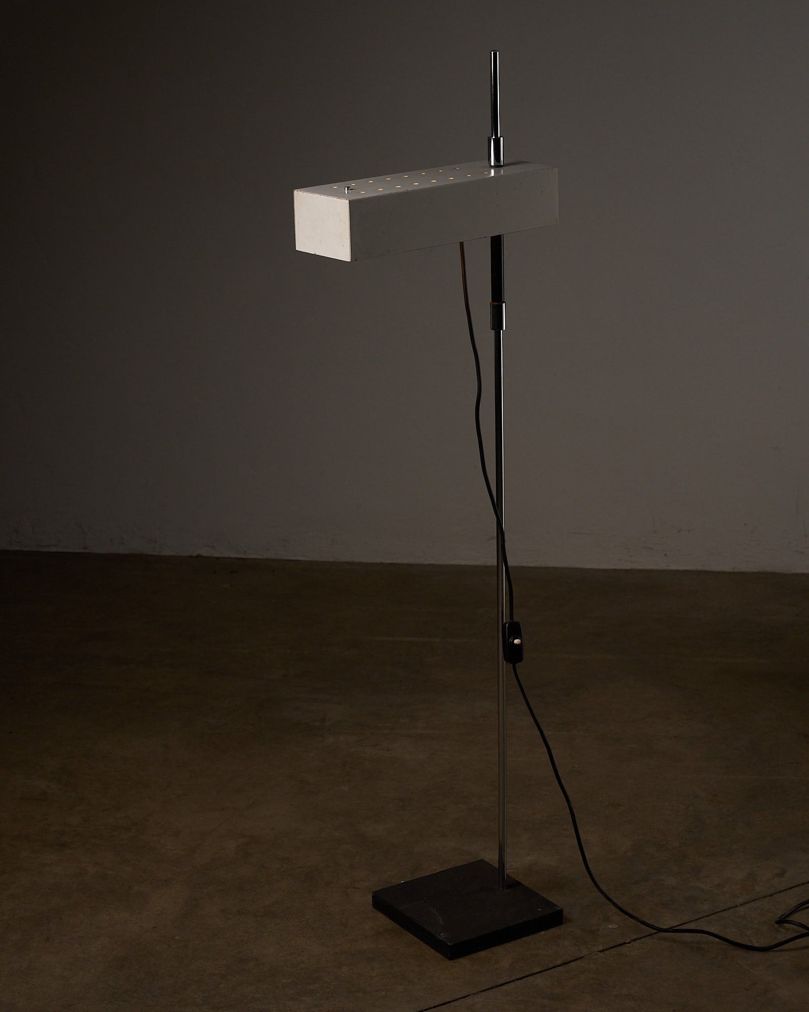 Adjustable Perforated Shade Floor Lamp with modern design and sleek metal finish.