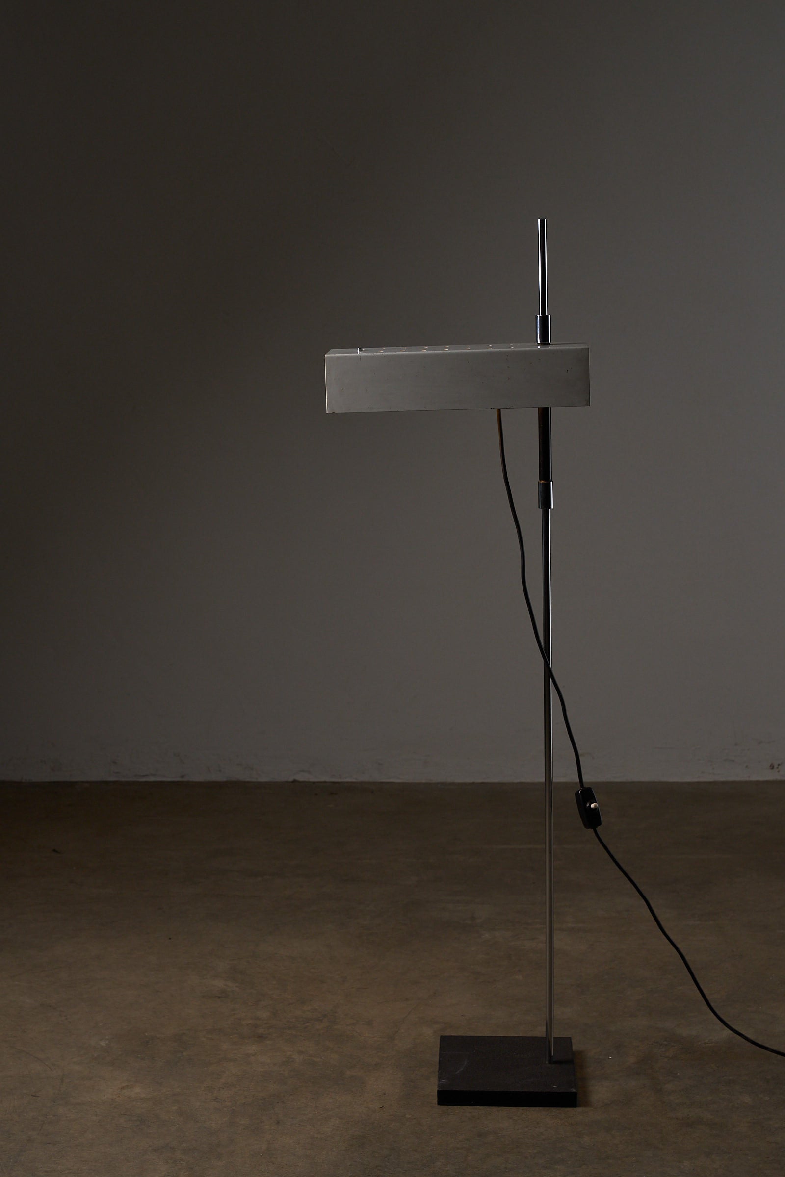 Adjustable Perforated Shade Floor Lamp in sleek metal design with a chromed base and perforated light shade.