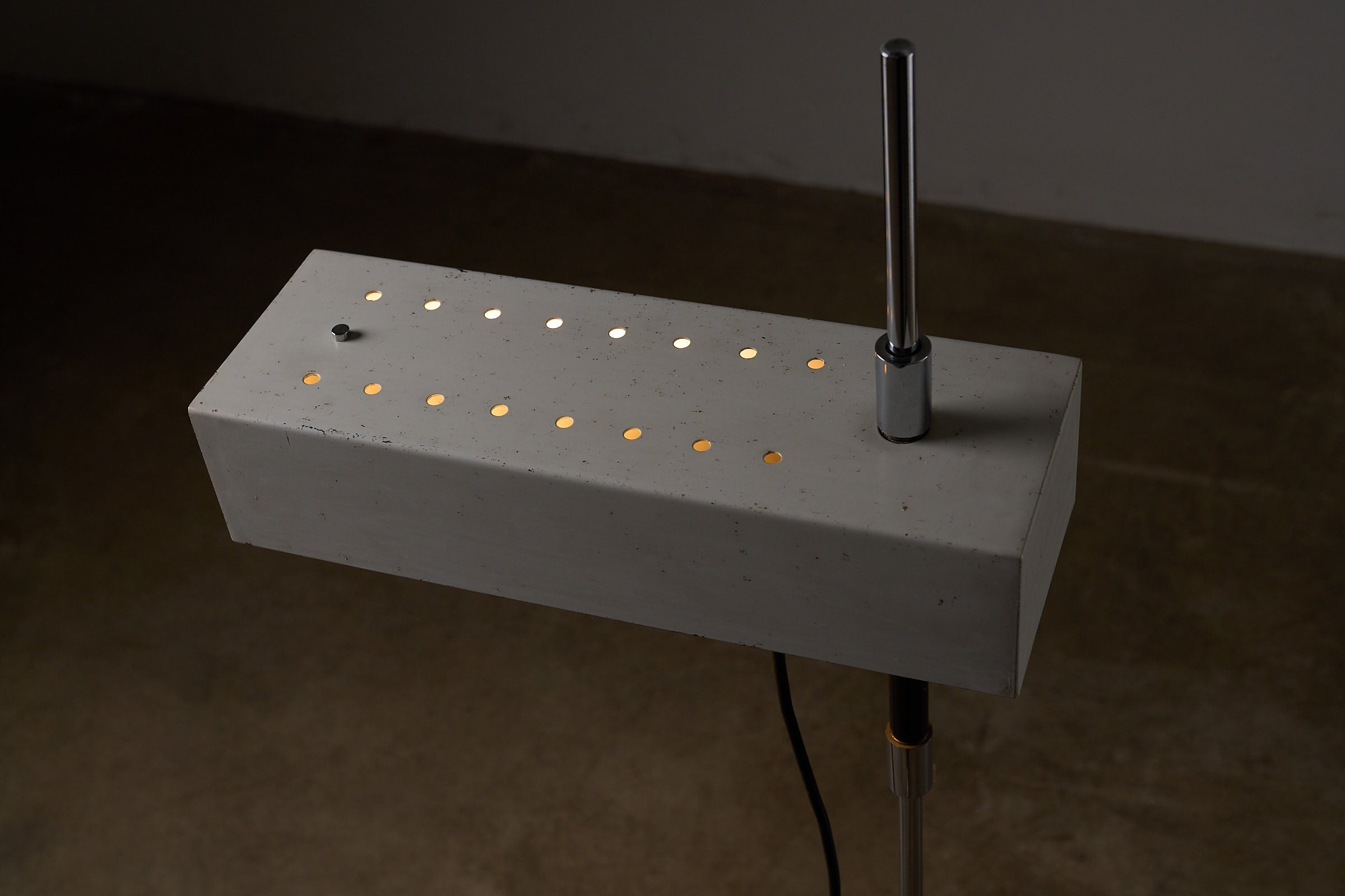 Adjustable Perforated Shade Floor Lamp in stylish gray with perforated design and sleek chrome details.