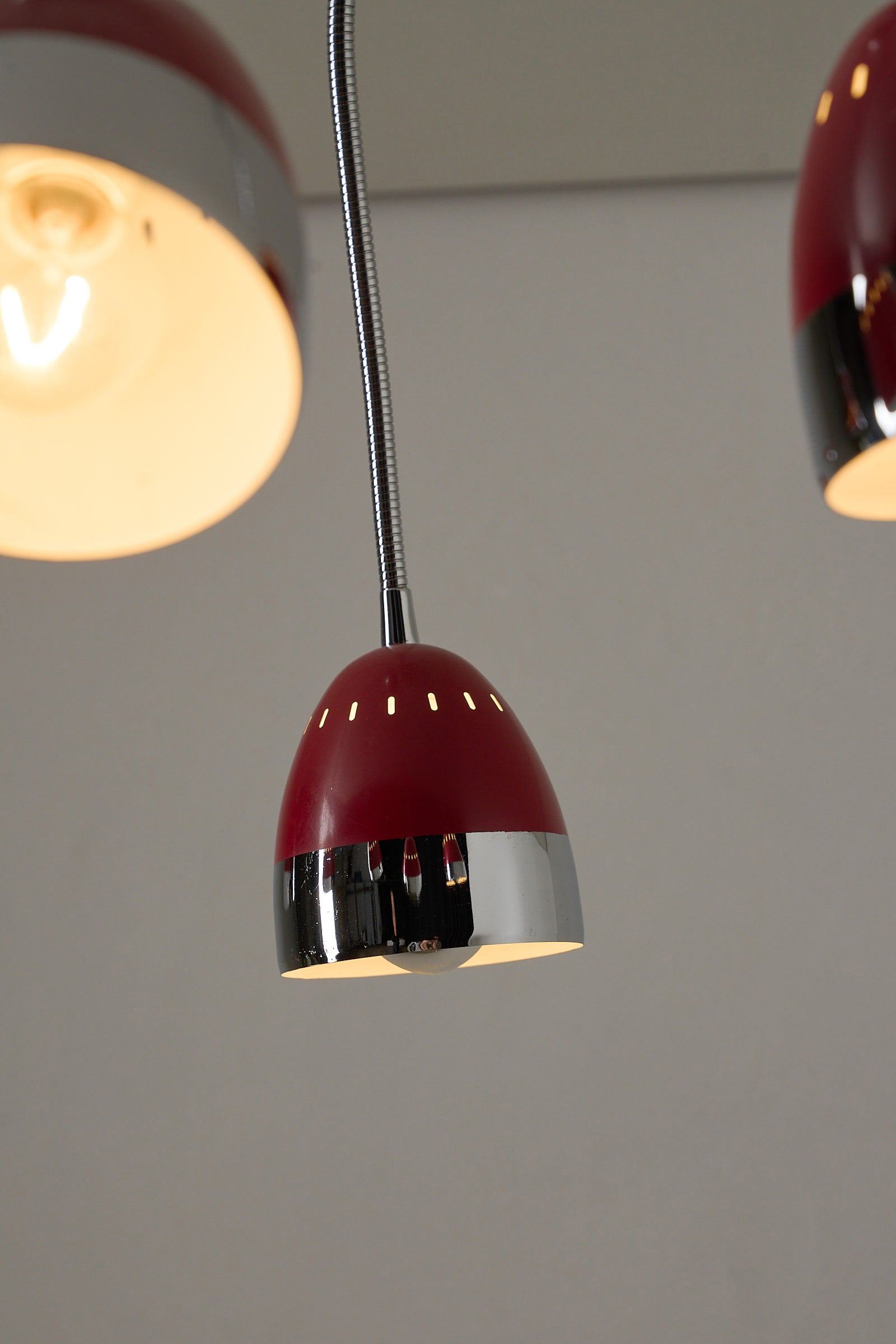 Six-Arm Flexible Ceiling Lamp, Chrome & Bordeaux with flexible red enamel shade and chrome finish.