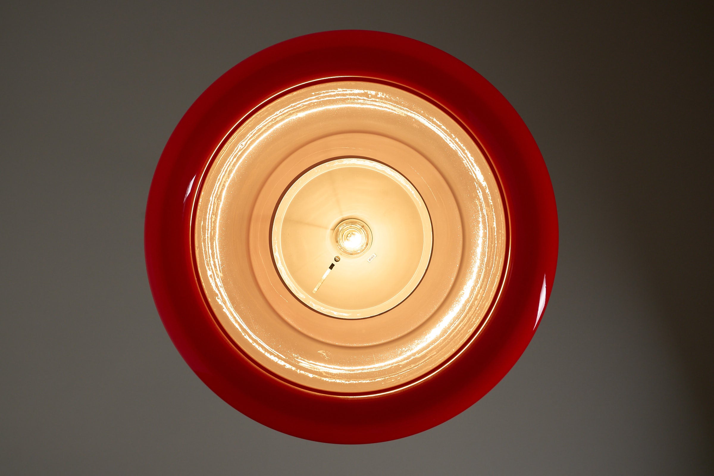 Cosack red acrylic ceiling lamp with chrome detail, Germany, 1970s viewed from above, showcasing its vibrant color and design.