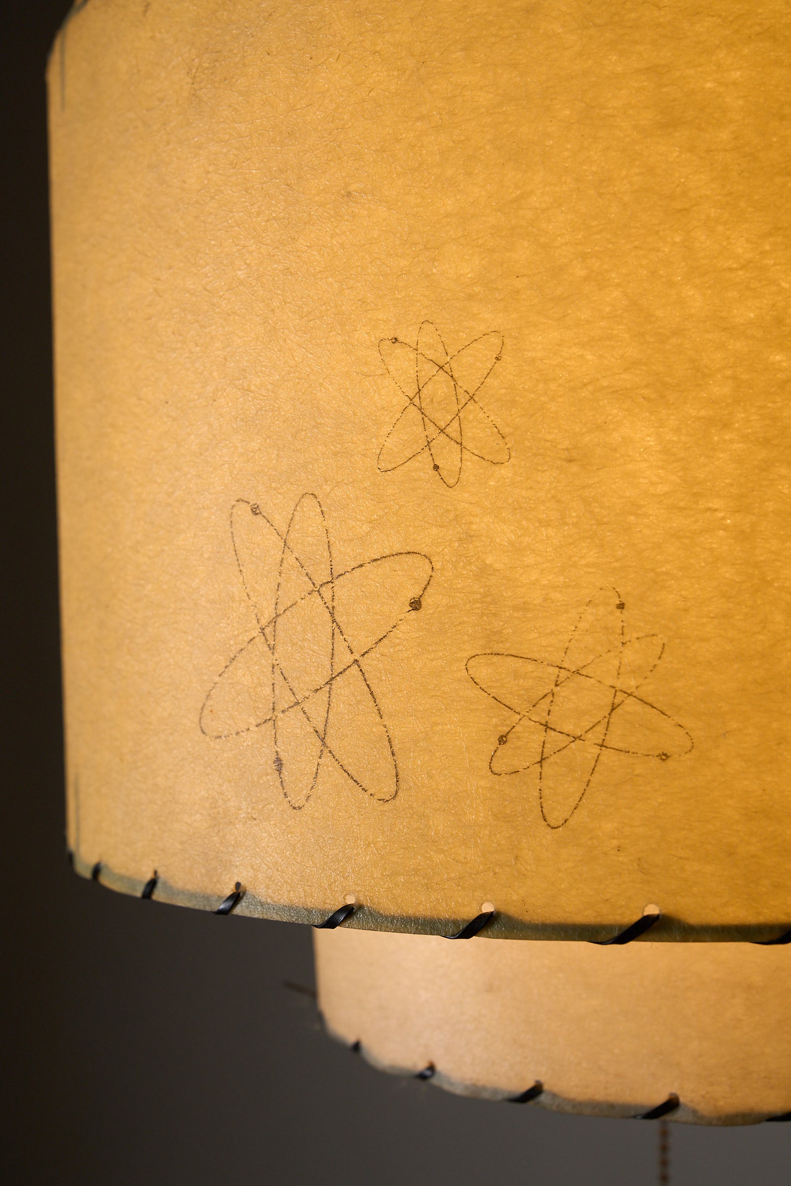 Atomic Pendant Lamp by Archaic Smile Inc featuring atomic pattern detail on parchment shade.