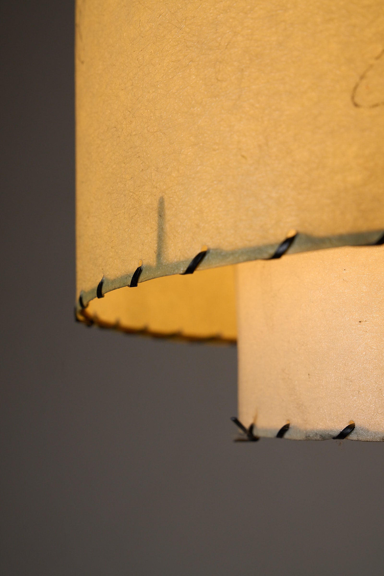Atomic Pendant Lamp by Archaic Smile Inc close-up of layered parchment shade with hand-laced edge.