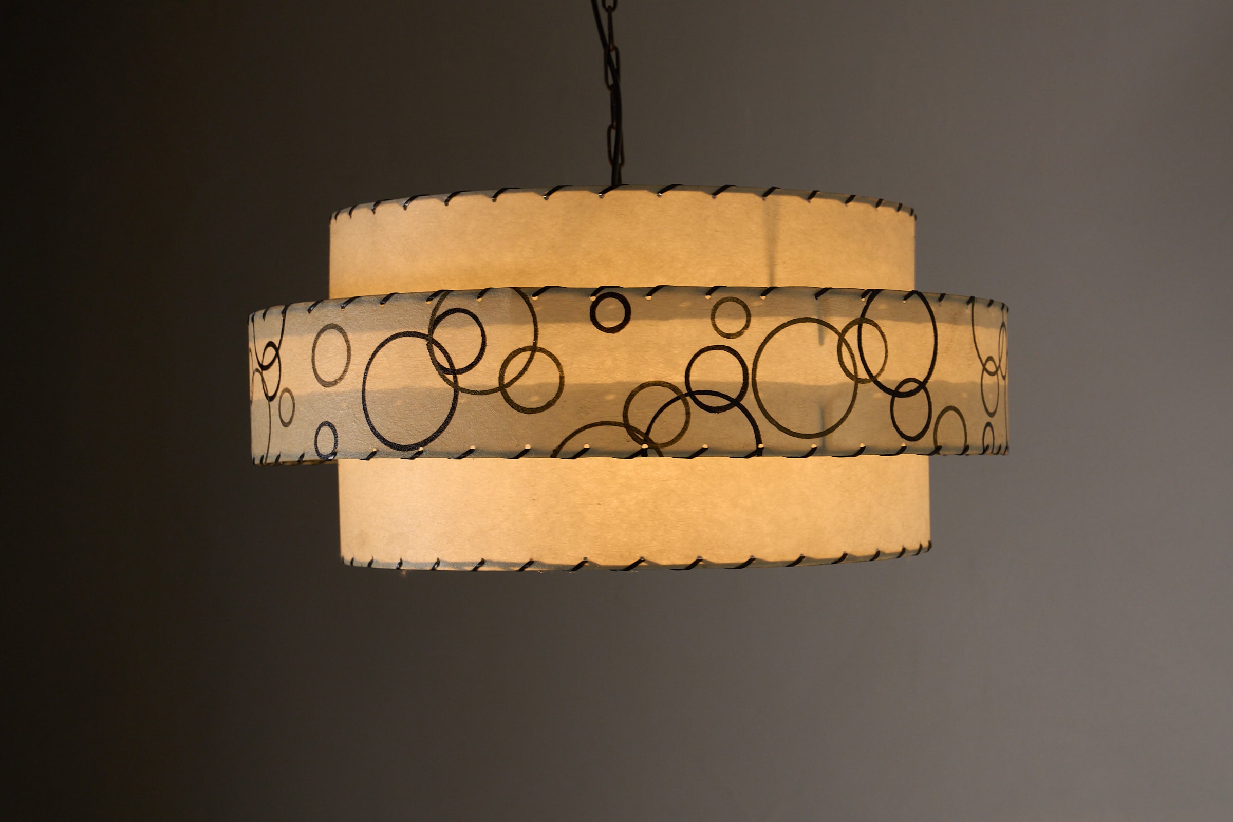 Bubble Motif Pendant Lamp by Archaic Smile Inc. with double-tiered shade and bubble pattern.