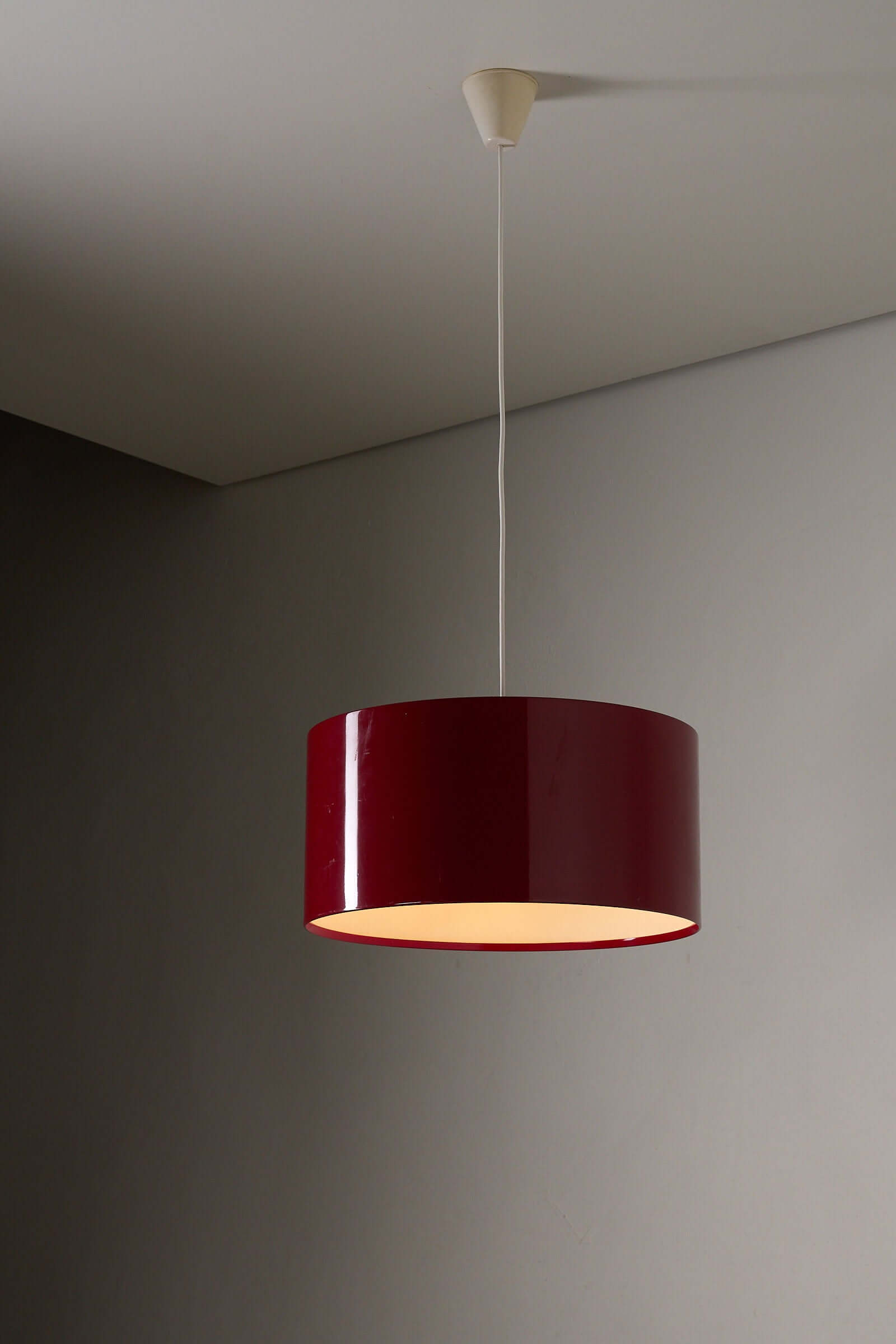 Fog & Mørup Drum Pendant in Bordeaux hanging elegantly from the ceiling.