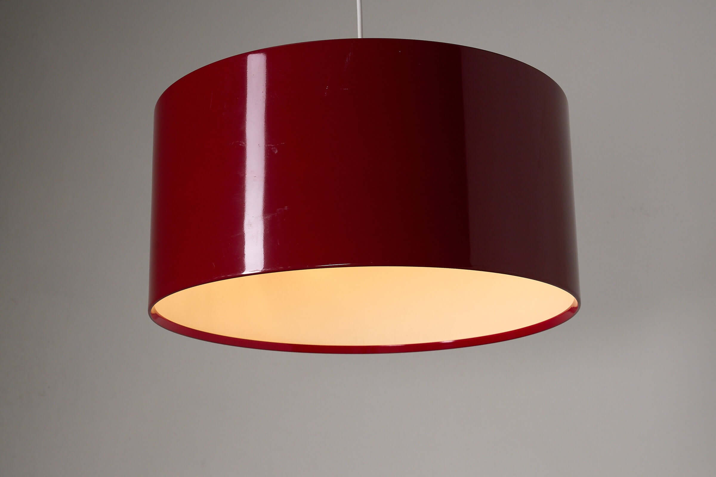 Fog & Mørup Drum Pendant in Bordeaux hanging lamp with cylindrical metal shade and warm glow.