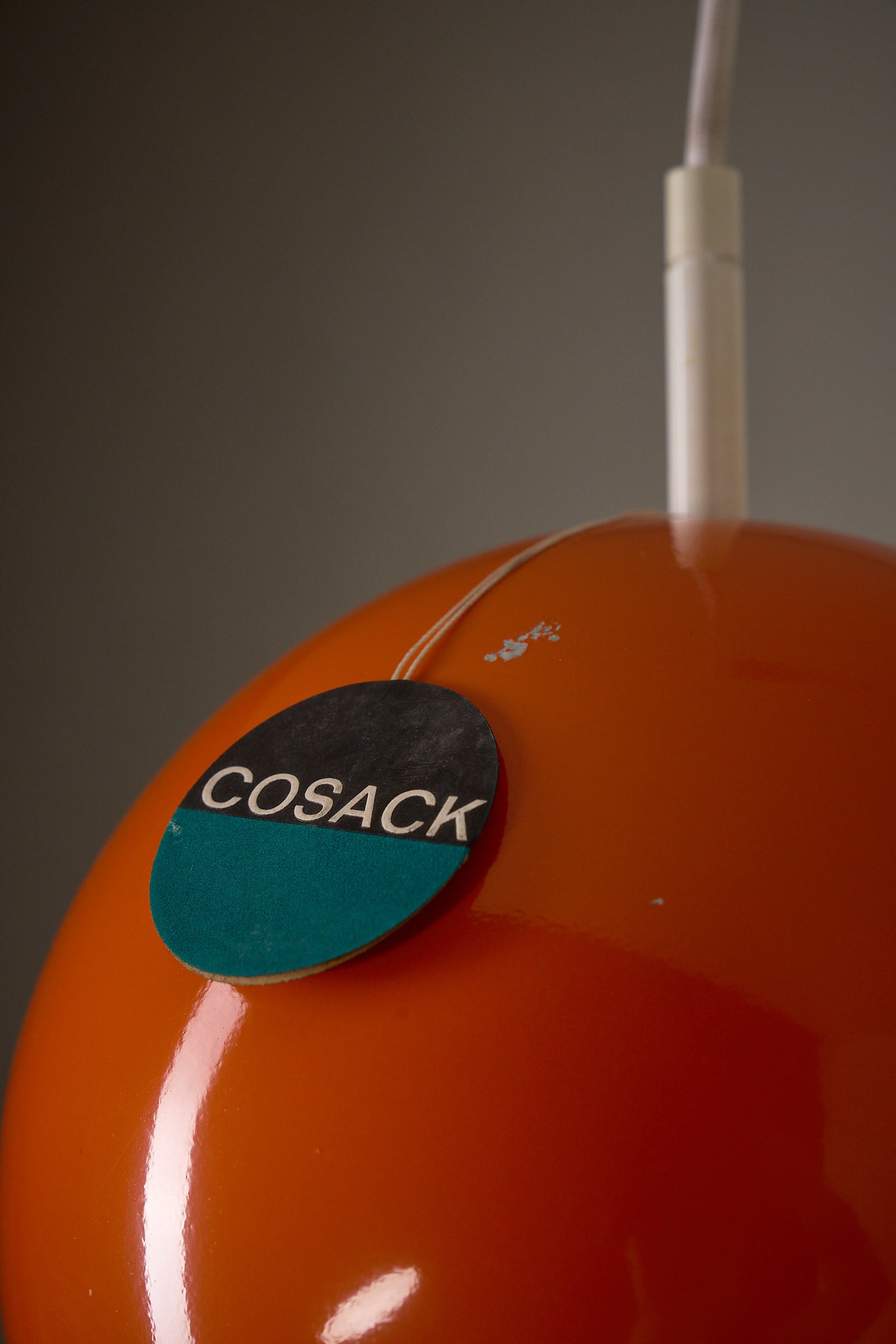 Orange Sphere Pendant by Karl-Heinz Kinsky for Cosack with a close-up view of the brand tag.