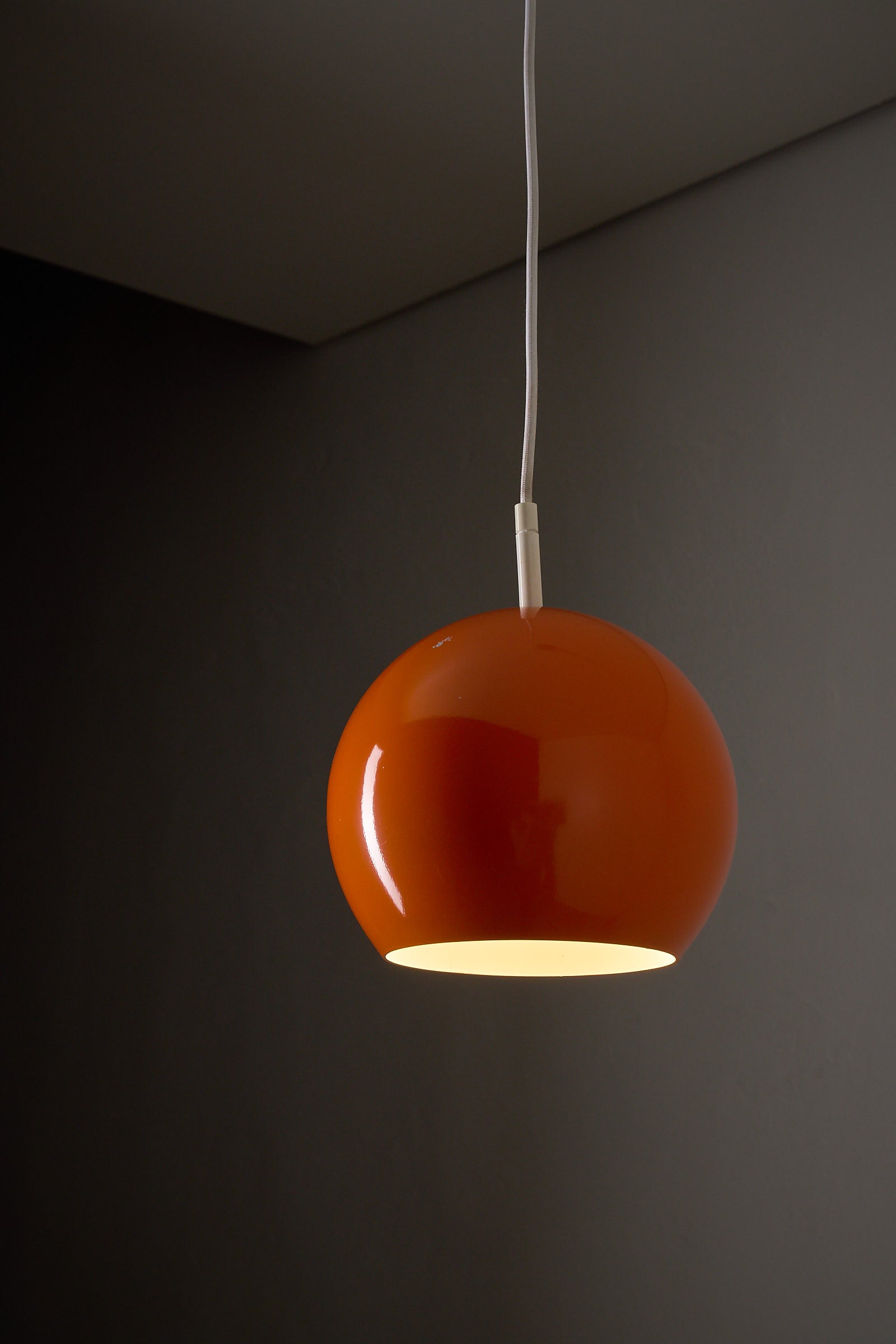 Orange Sphere Pendant by Karl-Heinz Kinsky for Cosack, a glossy orange ceiling lamp showcasing mid-century design.