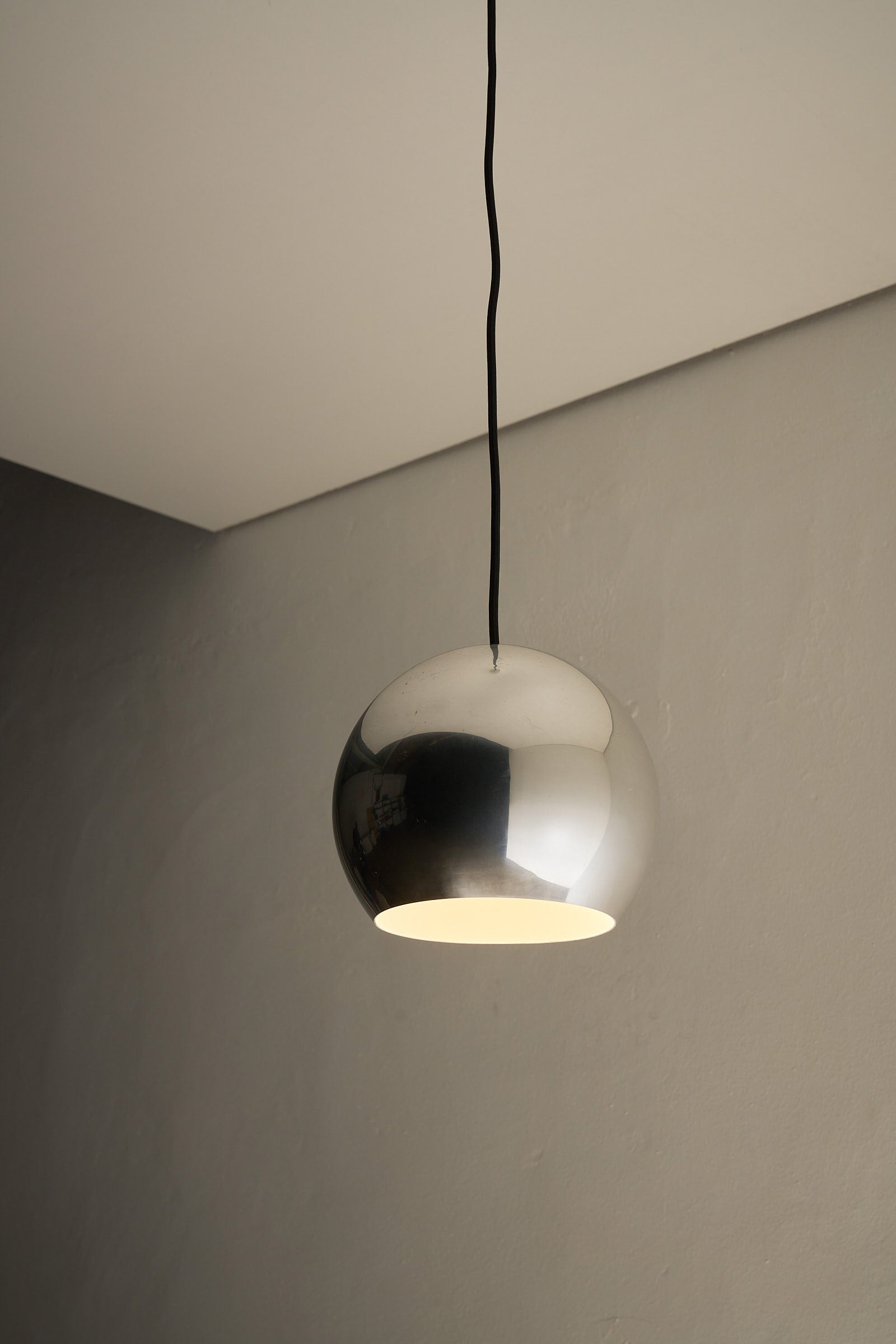 Chrome Sphere Pendant, sleek chrome ceiling light with minimalist design, showcasing mid-century elegance.