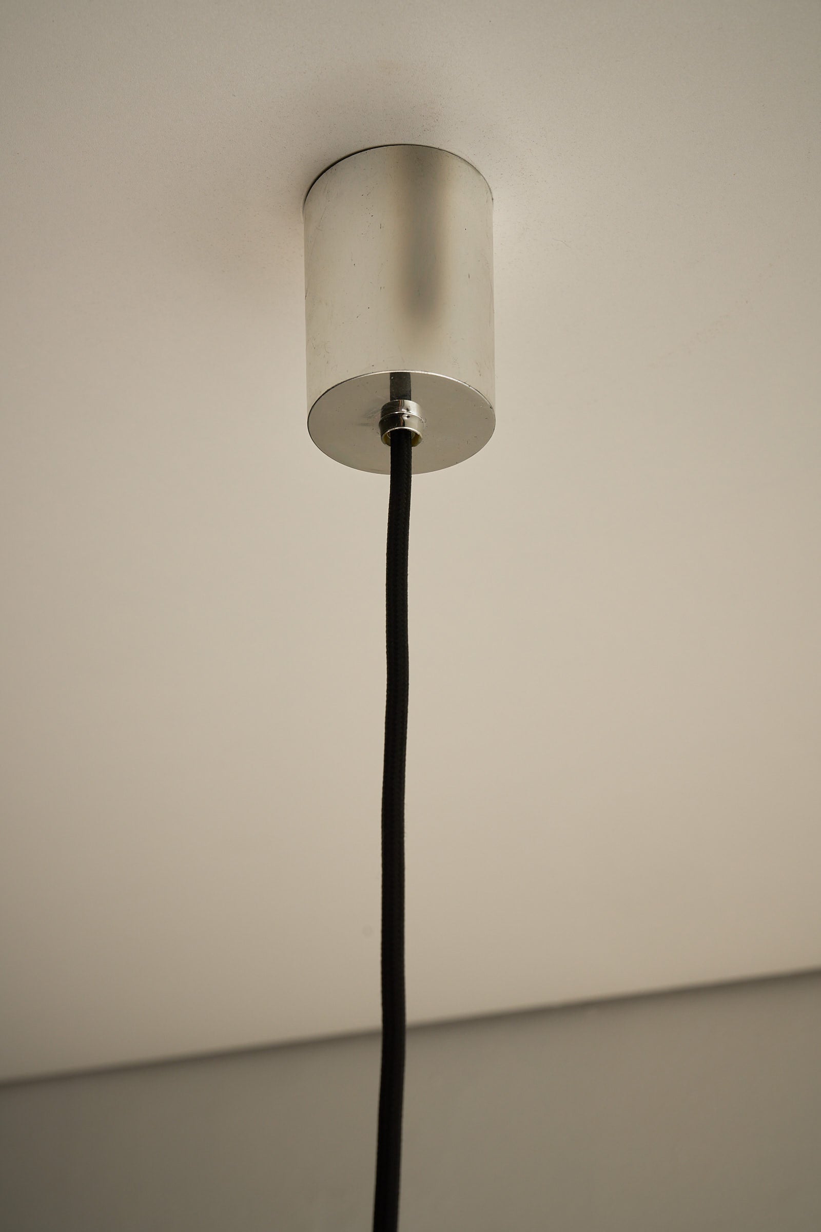 Chrome Sphere Pendant ceiling lamp mounting detail with black cord and chrome finish.