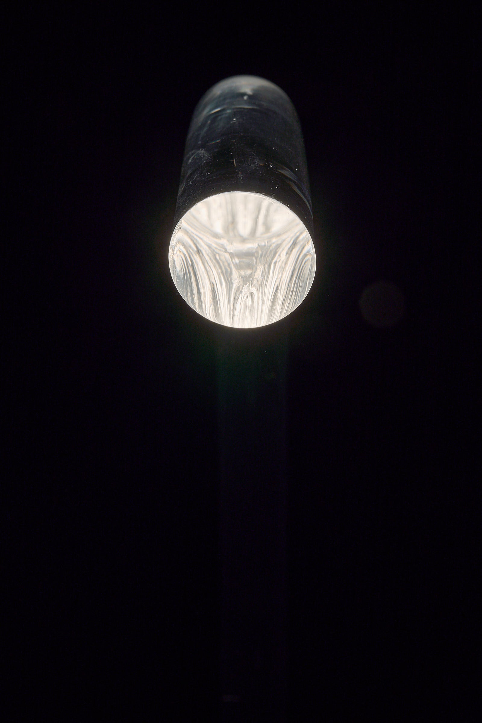 Close-up view of the top of the "King" Floor Lamp by Edy ten Berge, showcasing its clear acrylic design and light source.