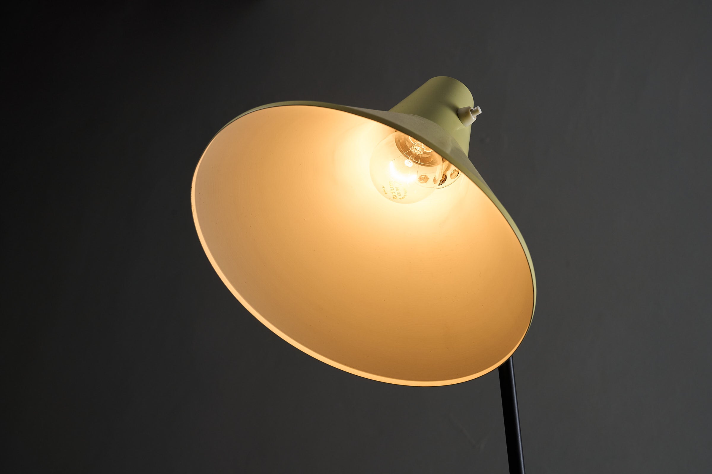 Grasshopper Tripod Floor Lamp by Willem van Doorn with yellow shade and light bulb glowing.